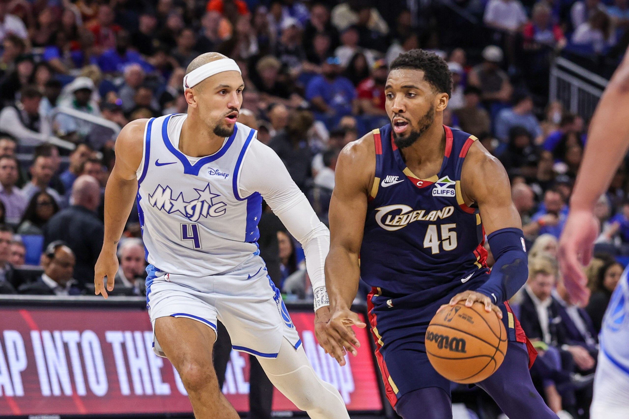 Mar 11, 2026; Orlando, Florida, USA; Cleveland Cavaliers guard Donovan Mitchell (45) drives to the basket against Orlando Magic guard Jalen Suggs (4) during the second half at Kia Center. Mandatory Credit: Mike Watters-Imagn Images