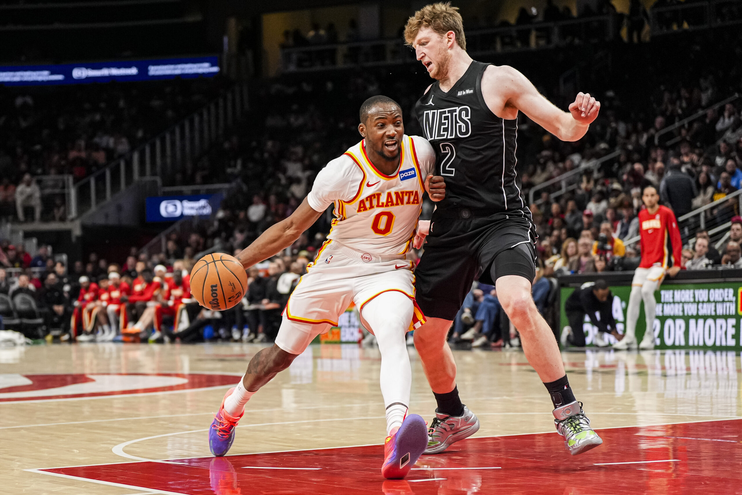 Mar 12, 2026; Atlanta, Georgia, USA; Atlanta Hawks forward Jonathan Kuminga (0) dribbles against Brooklyn Nets forward Danny Wolf (2) during the second half at State Farm Arena. Mandatory Credit: Dale Zanine-Imagn Images