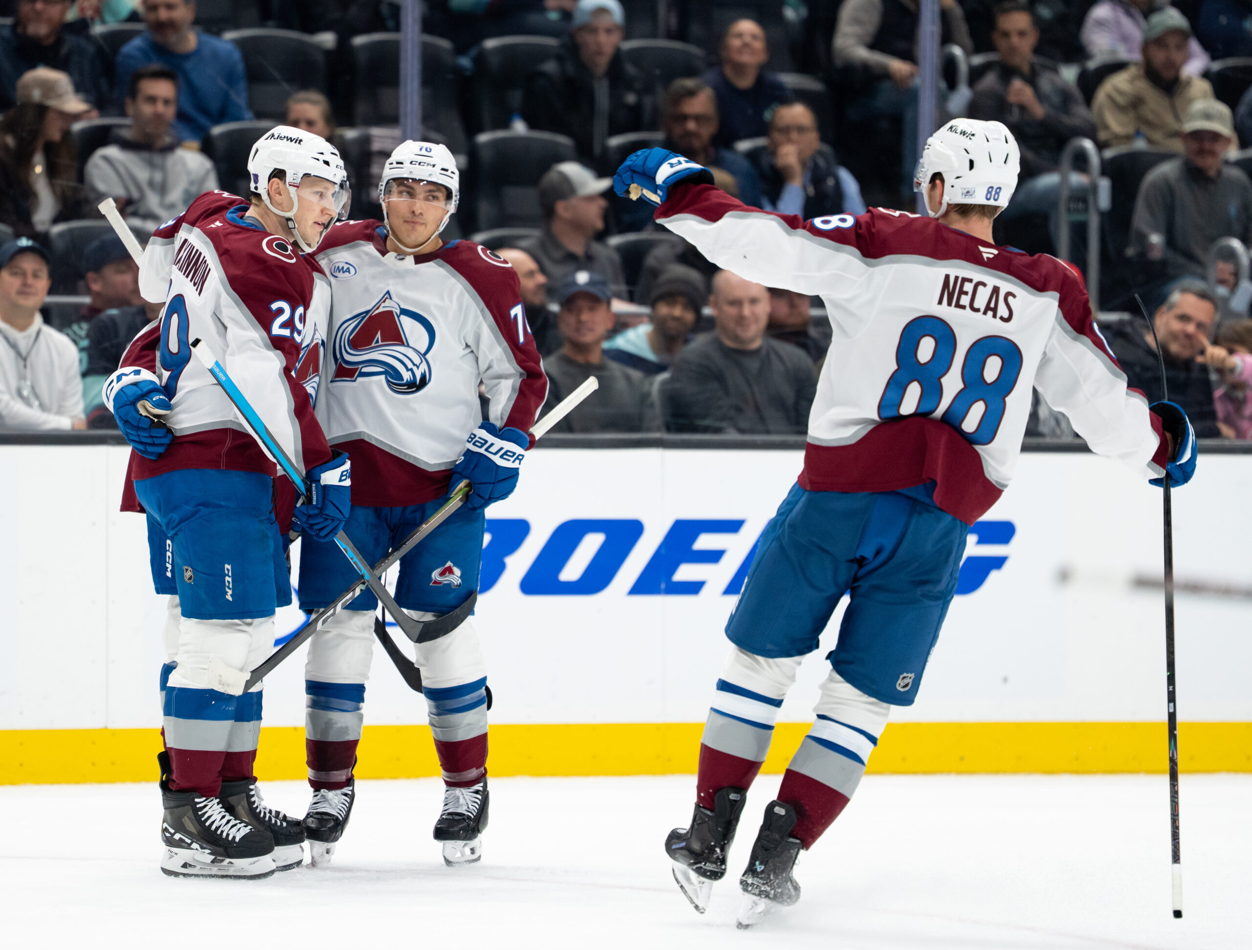 Mar 12, 2026; Seattle, Washington, USA; Colorado Avalanche, from left, forward Nathan MacKinnon (29) defenseman Sam Malinski (70) and forward Martin Necas (88) celebrate a goal during the second period against the Seattle Kraken at Climate Pledge Arena. Mandatory Credit: Stephen Brashear-Imagn Images