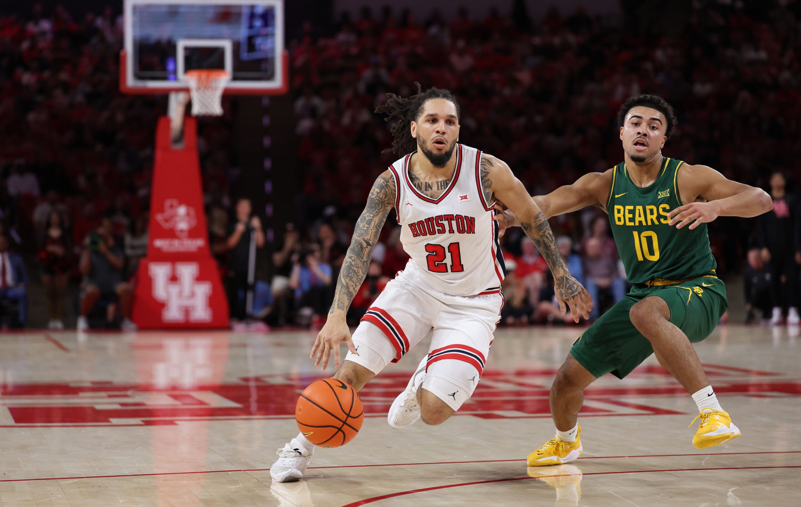 Mar 4, 2026; Houston, Texas, USA;  Houston Cougars guard Emanuel Sharp (21) dribbles against Baylor Bears guard Isaac Williams (10) in the first half at Fertitta Center. Mandatory Credit: Thomas Shea-Imagn Images