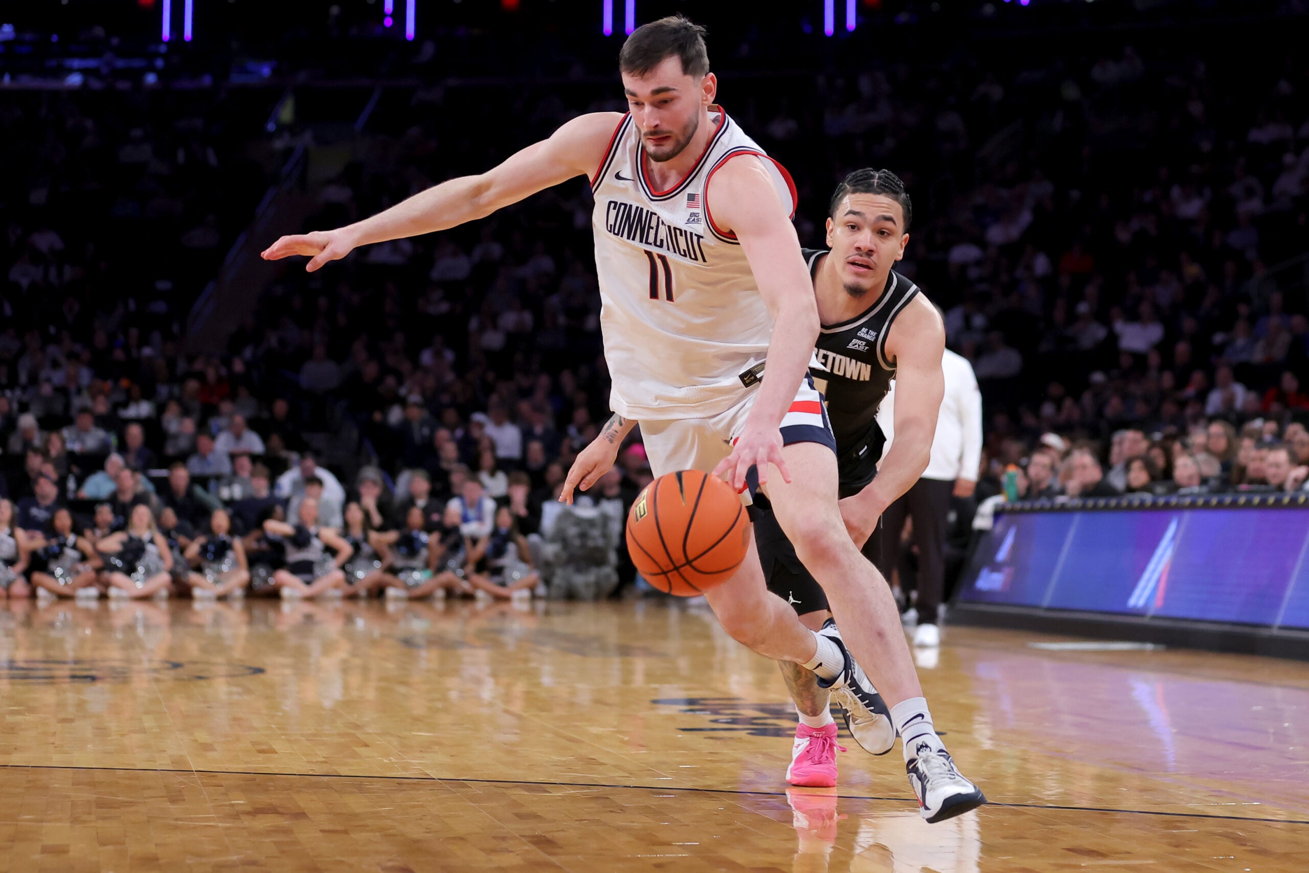 Mar 13, 2026; New York, NY, USA; Connecticut Huskies forward Alex Karaban (11) drives to the basket around Georgetown Hoyas forward Caleb Williams (4) during the second half at Madison Square Garden. Mandatory Credit: Brad Penner-Imagn Images