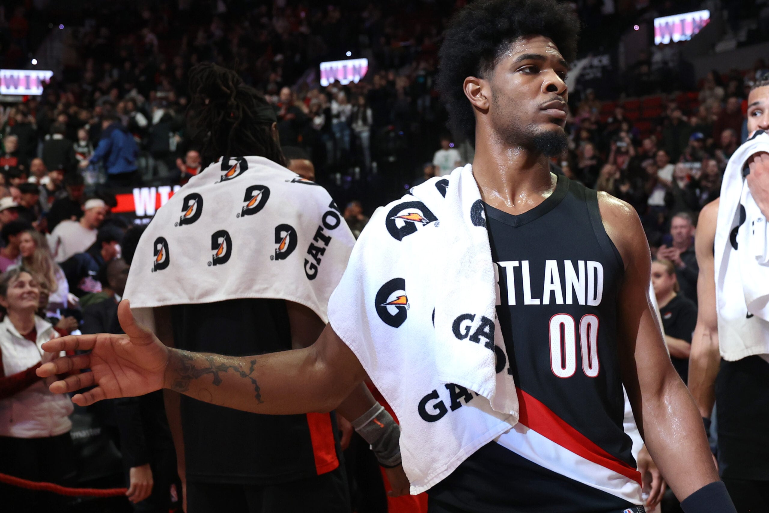 Mar 13, 2026; Portland, Oregon, USA;  Portland Trail Blazers guard Scoot Henderson (00) high-fives teammates after the Trail Blazers defeated Utah Jazz 124-114 at Moda Center. Mandatory Credit: Jaime Valdez-Imagn Images