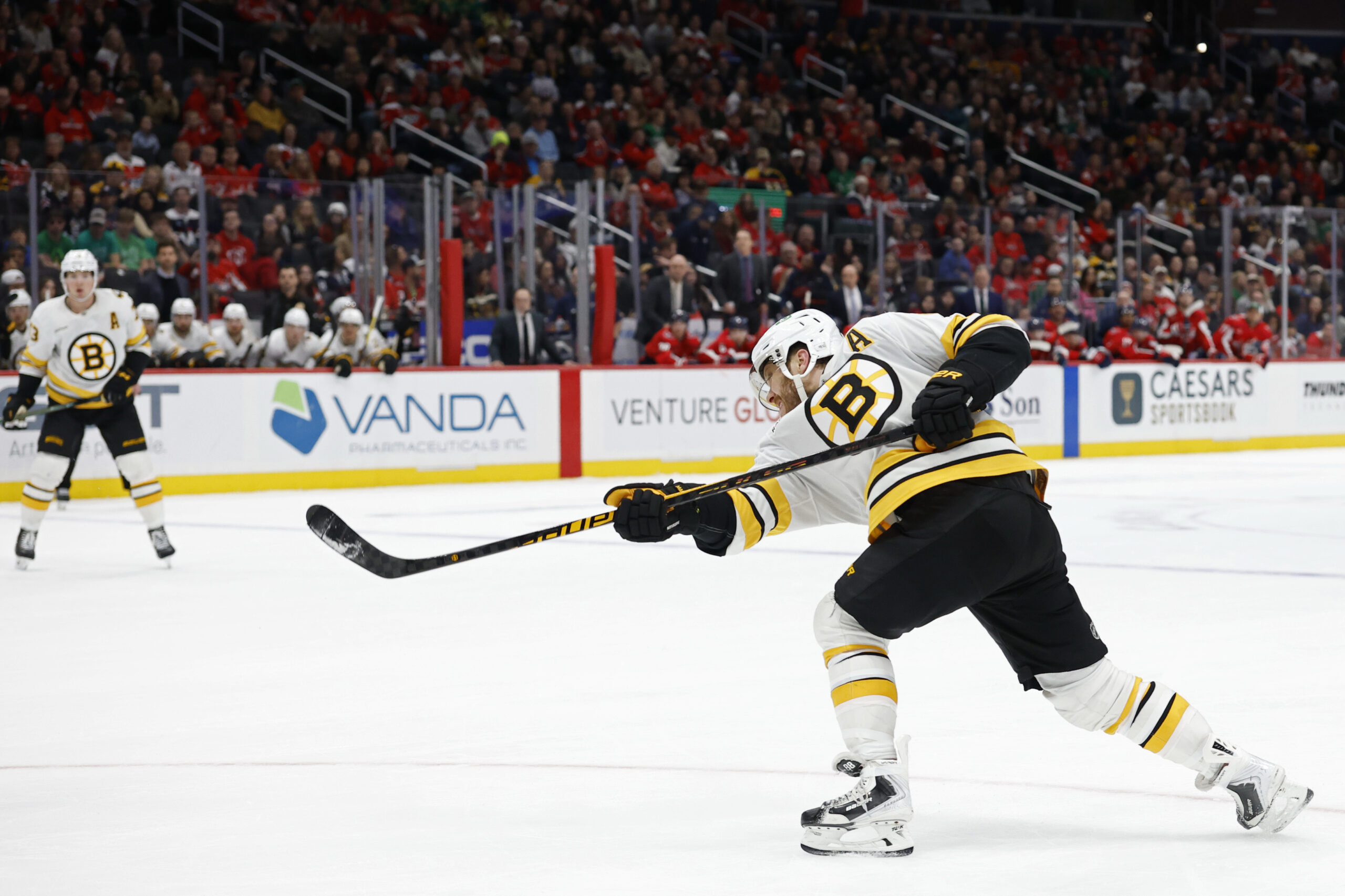 Mar 9, 2026; Washington, District of Columbia, USA; Boston Bruins right wing David Pastrnak (88) shoots the puck against the Washington Capitals in overtime at Capital One Arena. Mandatory Credit: Geoff Burke-Imagn Images