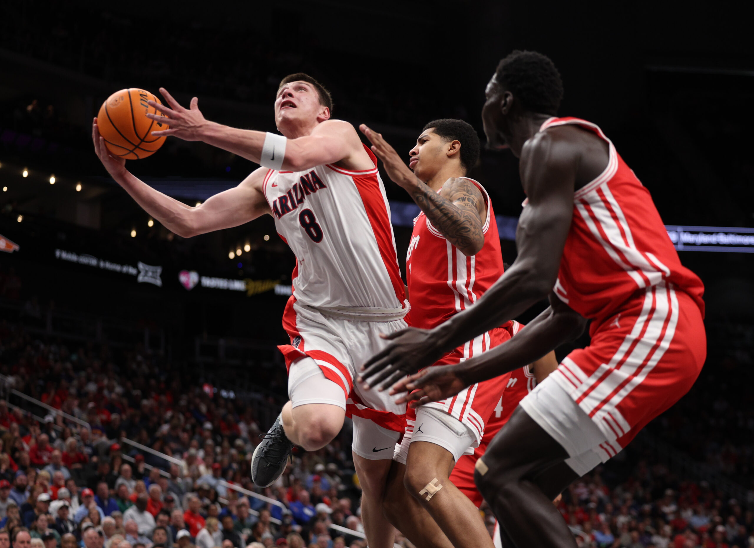 Mar 14, 2026; Kansas City, MO, USA; Arizona Wildcats forward Ivan Kharchenkov (8) drives to the hoop past Houston Cougars forward Chase McCarty (24) during the first half during the men's Big 12 Conference Tournament Championship at T-Mobile Center. Mandatory Credit: William Purnell-Imagn Images