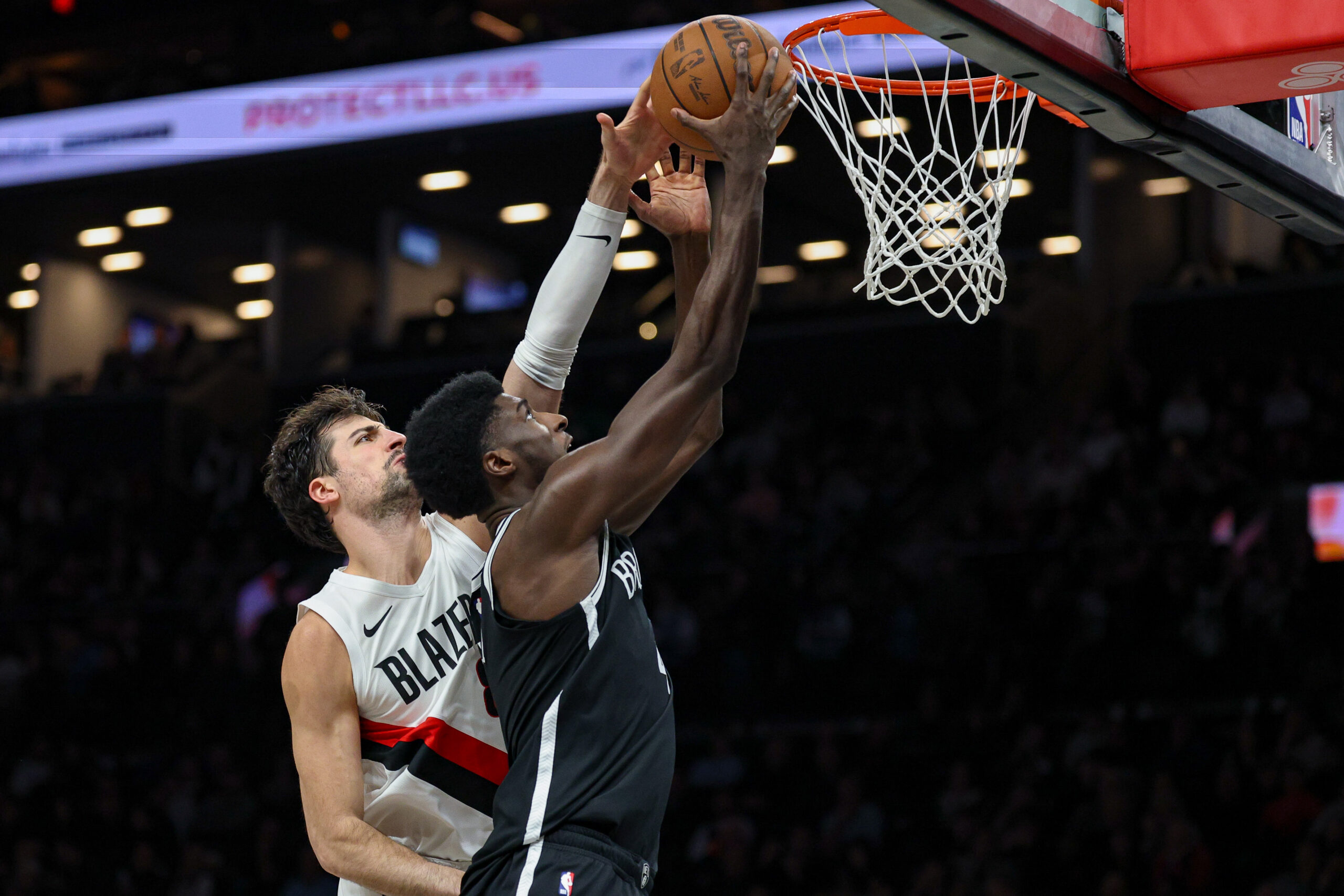 Mar 16, 2026; Brooklyn, New York, USA; Brooklyn Nets guard Drake Powell (4) goes to the basket against Portland Trail Blazers forward Deni Avdija (8) during the second half at Barclays Center. Mandatory Credit: Vincent Carchietta-Imagn Images