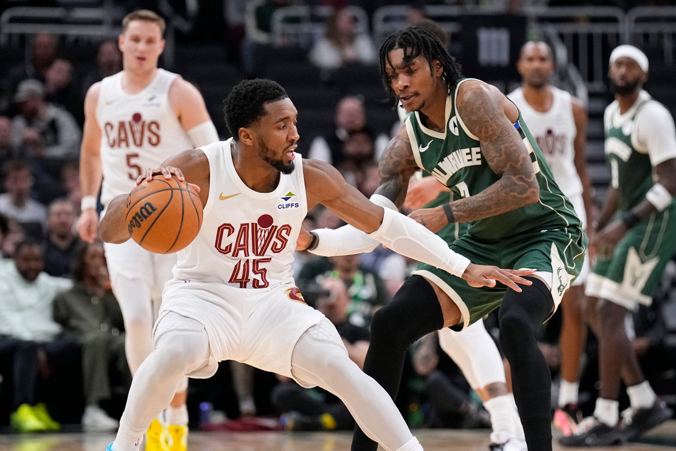 Mar 17, 2026; Milwaukee, Wisconsin, USA; Cleveland Cavaliers guard Donovan Mitchell (45) drives against Milwaukee Bucks guard/forward Kevin Porter Jr. (7) in the second half at Fiserv Forum. Mandatory Credit: Michael McLoone-Imagn Images