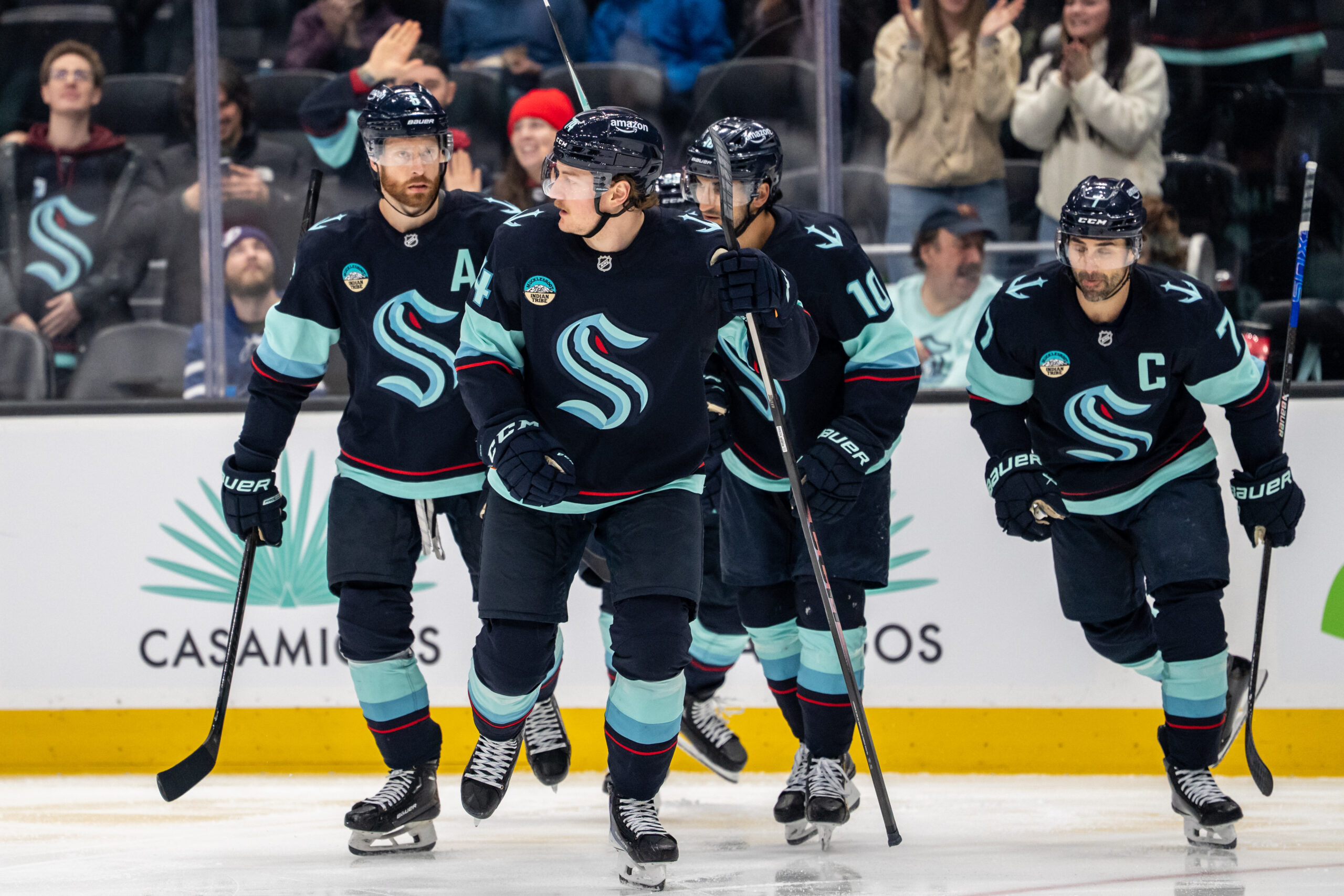 Mar 17, 2026; Seattle, Washington, USA; Seattle Kraken forward Bobby McMann (74), second from left, skates off the ice with defenseman Adam Larsson (6), left, forward Matty Beniers (10), and forward Jordan Eberle (7) after scoring a goal during the second period against the Tampa Bay Lightning at Climate Pledge Arena. Mandatory Credit: Stephen Brashear-Imagn Images