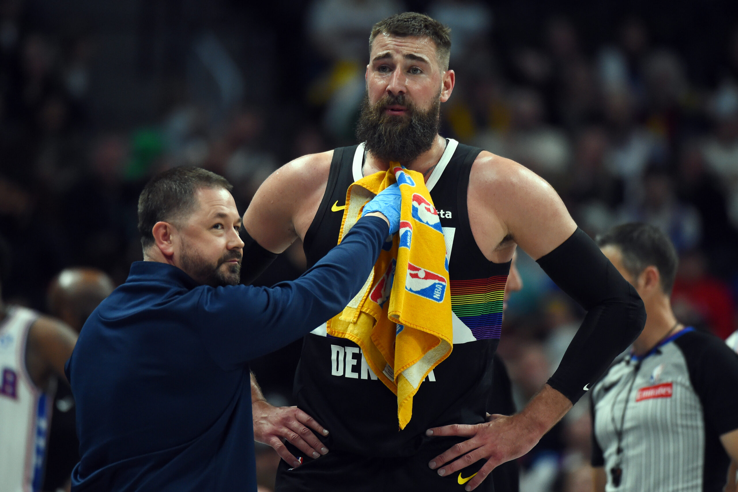 Mar 17, 2026; Denver, Colorado, USA; Denver Nuggets center Jonas Valanciunas (17) has blood wiped from his chest during the second half against the Philadelphia 76ers at Ball Arena. Mandatory Credit: Christopher Hanewinckel-Imagn Images