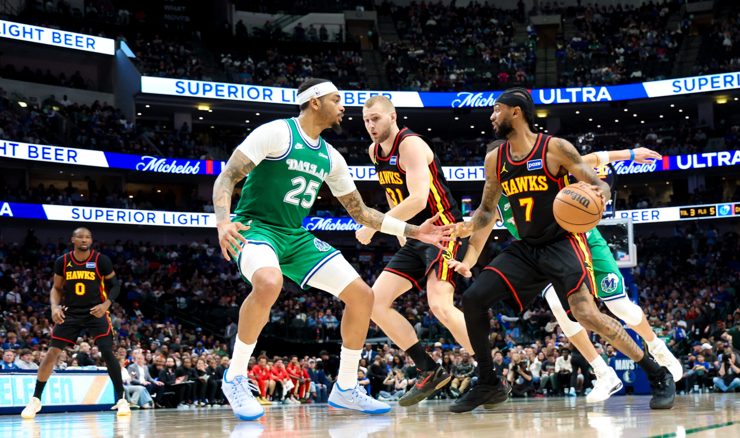 Mar 18, 2026; Dallas, Texas, USA; Atlanta Hawks guard Nickeil Alexander-Walker (7) controls the ball as Dallas Mavericks forward P.J. Washington (25) defends during the second half at American Airlines Center. Mandatory Credit: Kevin Jairaj-Imagn Images
