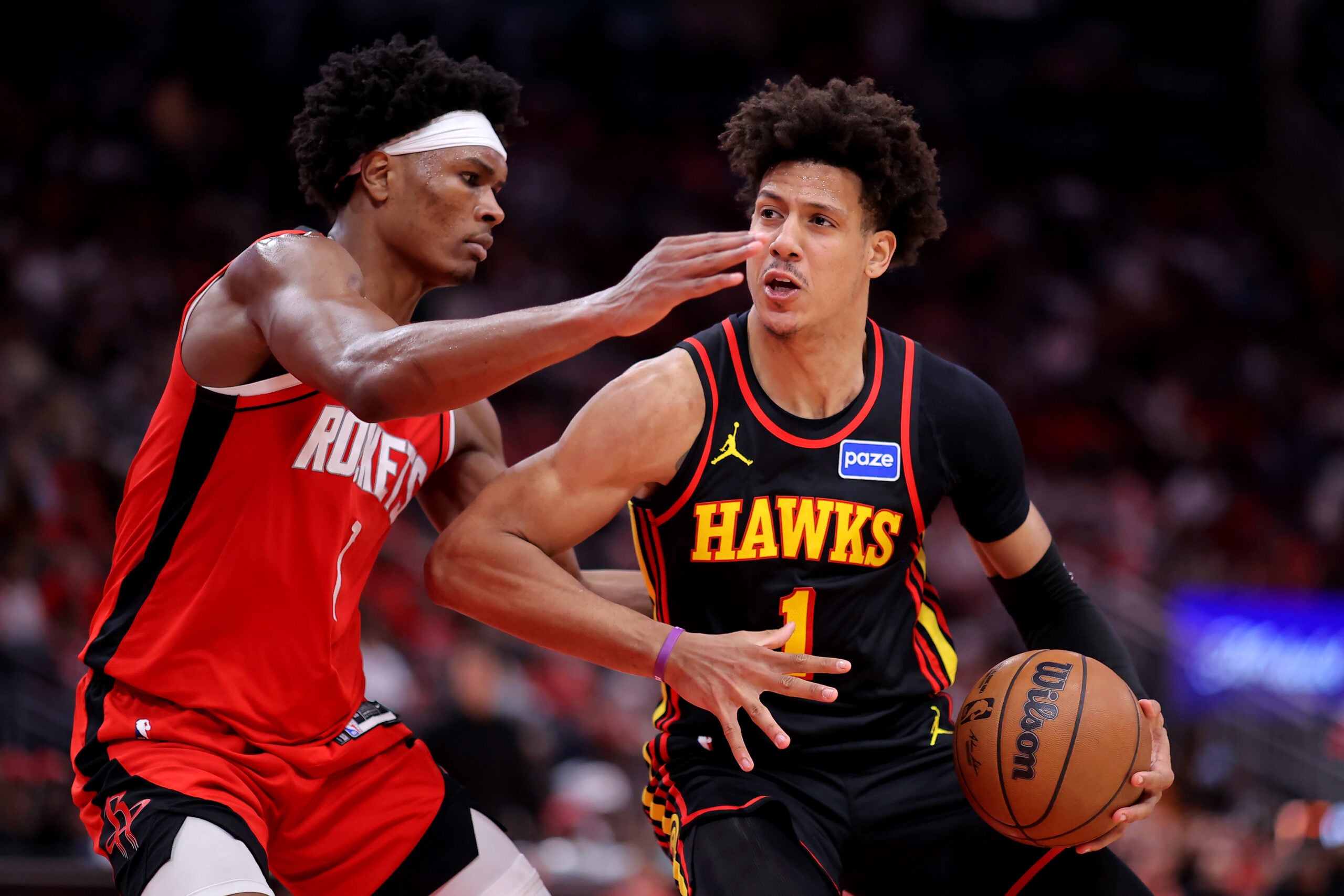 Mar 20, 2026; Houston, Texas, USA; Atlanta Hawks forward Jalen Johnson (1) drives to the basket against Houston Rockets guard Amen Thompson (1) during the fourth quarter at Toyota Center. Mandatory Credit: Erik Williams-Imagn Images