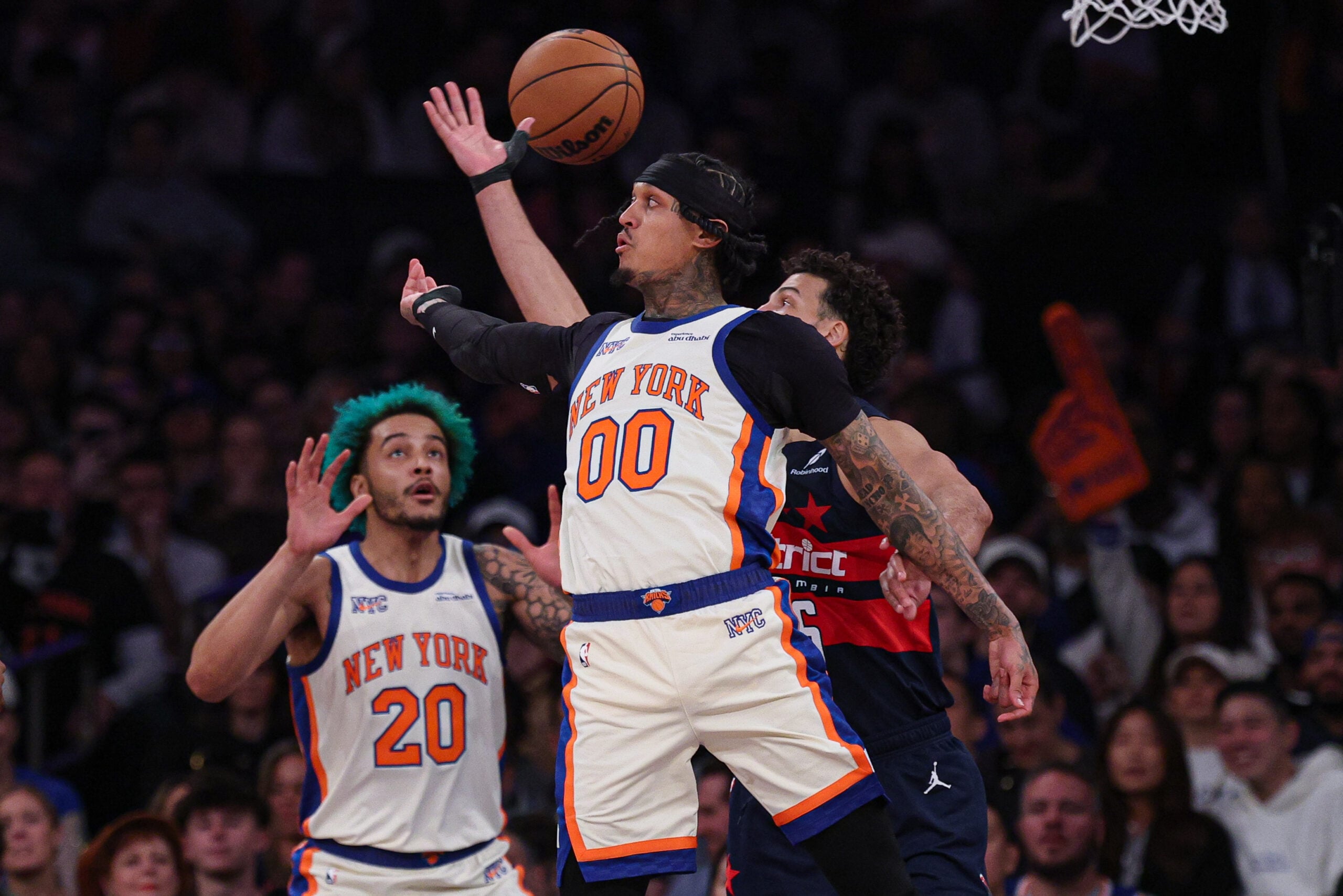 Mar 22, 2026; New York, New York, USA; New York Knicks guard Jordan Clarkson (00) tosses a no-look pass to forward Jeremy Sochan (20) during the second half against the Washington Wizards at Madison Square Garden. Mandatory Credit: Vincent Carchietta-Imagn Images