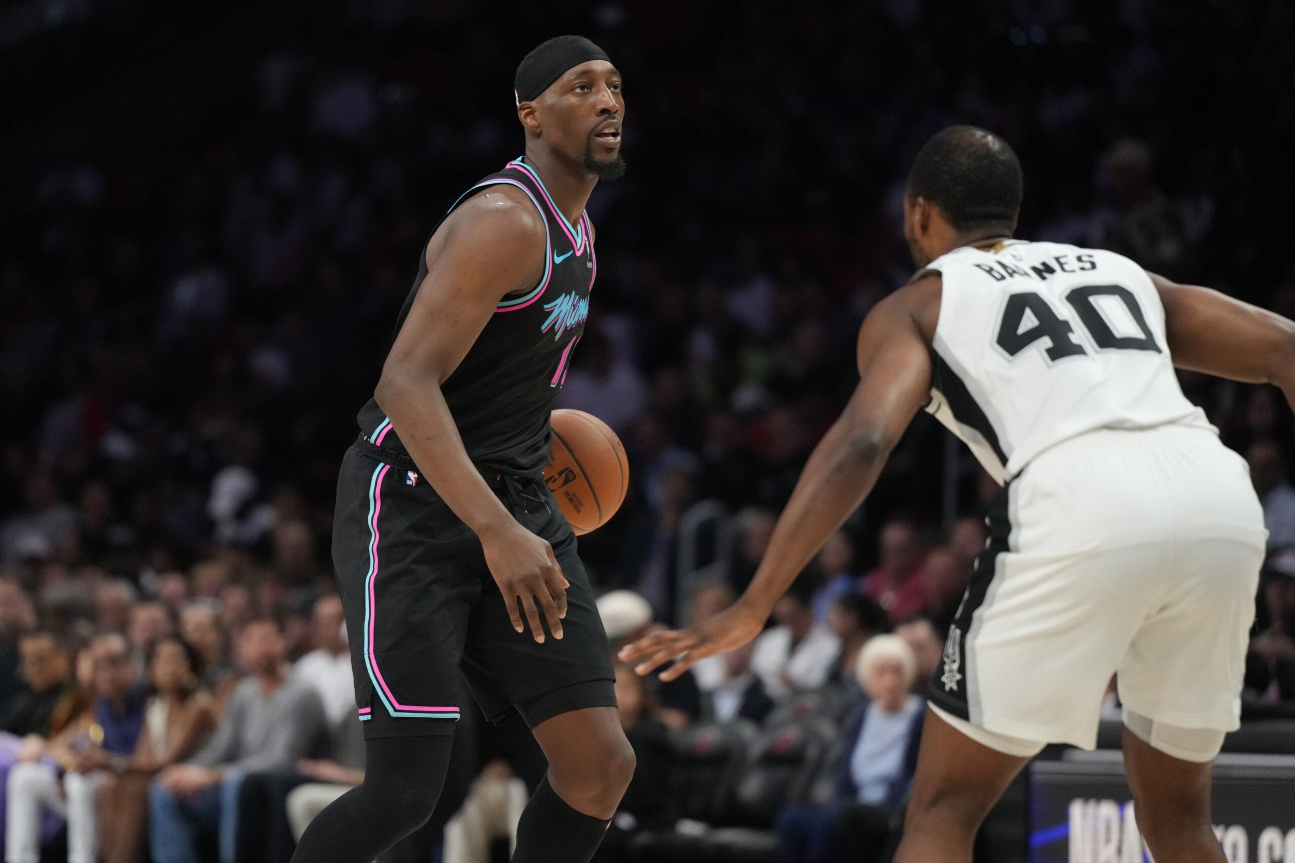 Mar 23, 2026; Miami, Florida, USA;  Miami Heat center Bam Adebayo (13) looks to pass the ball as San Antonio Spurs forward Harrison Barnes (40) defends during the first half at Kaseya Center. Mandatory Credit: Jim Rassol-Imagn Images