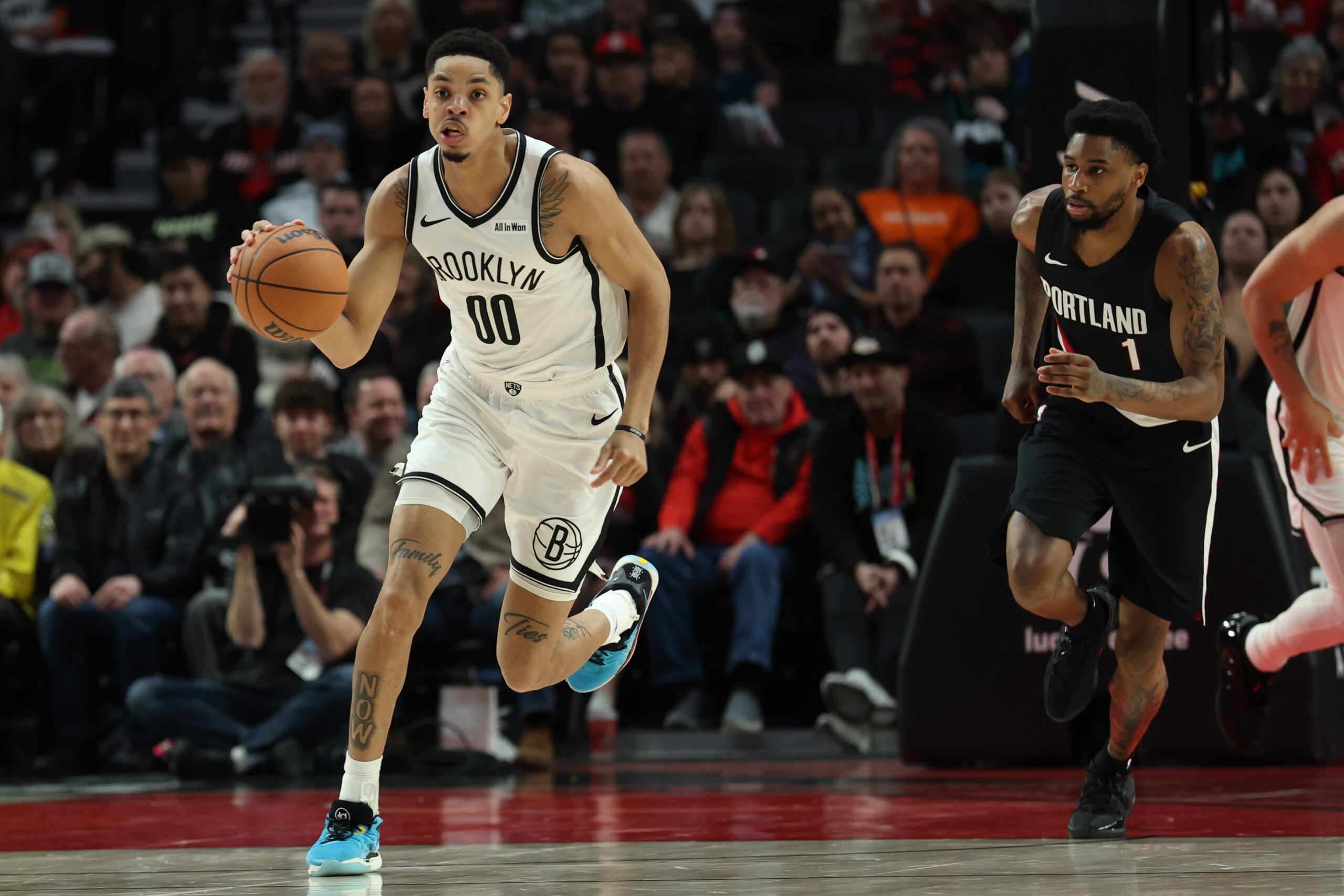 Mar 23, 2026; Portland, Oregon, USA; Brooklyn Nets forward Josh Minott (00) dribbles the ball past Portland Trail Blazers guard Blake Wesley (1) during the second half at Moda Center. Mandatory Credit: Jaime Valdez-Imagn Images