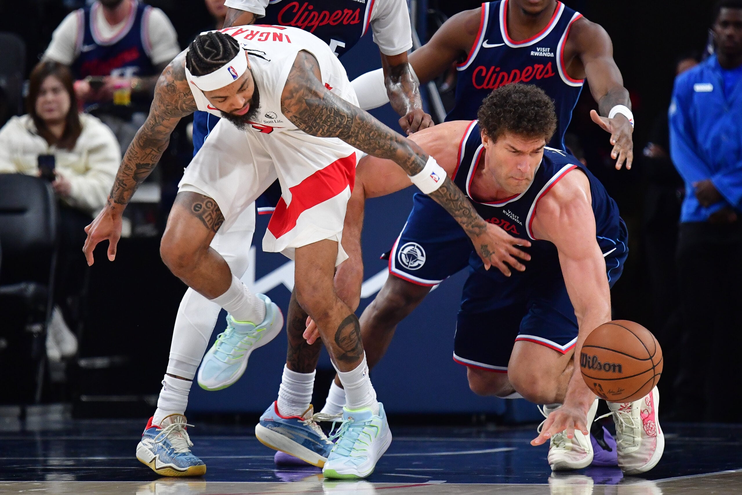 Mar 25, 2026; Inglewood, California, USA; Toronto Raptors forward Brandon Ingram (3) plays for the ball against Los Angeles Clippers center Brook Lopez (11) during the second half at Intuit Dome. Mandatory Credit: Gary A. Vasquez-Imagn Images