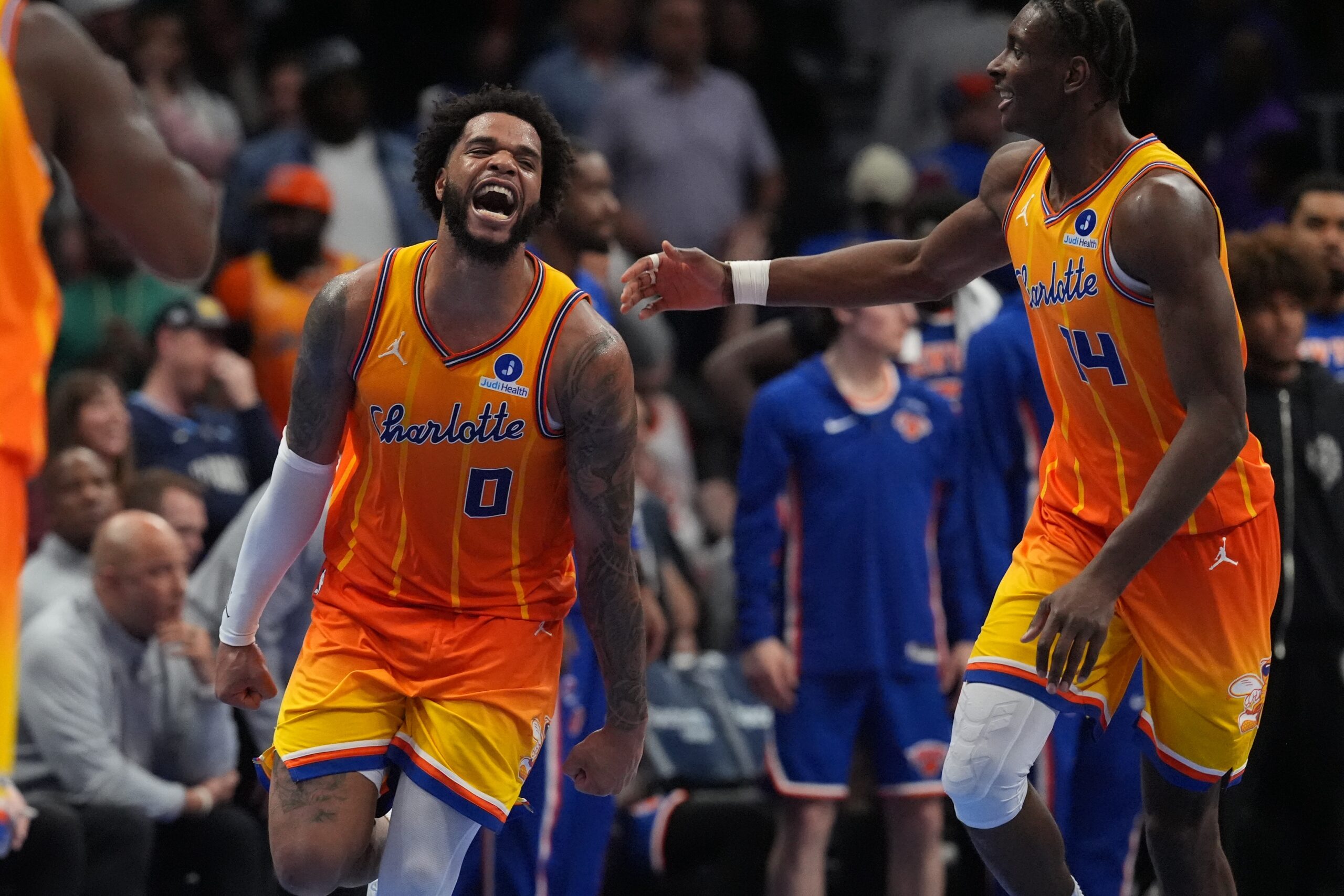 Mar 26, 2026; Charlotte, North Carolina, USA; Charlotte Hornets forward Miles Bridges (0) and forward Moussa Diabaté (14) react after a score against the New York Knicks during the second half at the Spectrum Center. Mandatory Credit: Jim Dedmon-Imagn Images