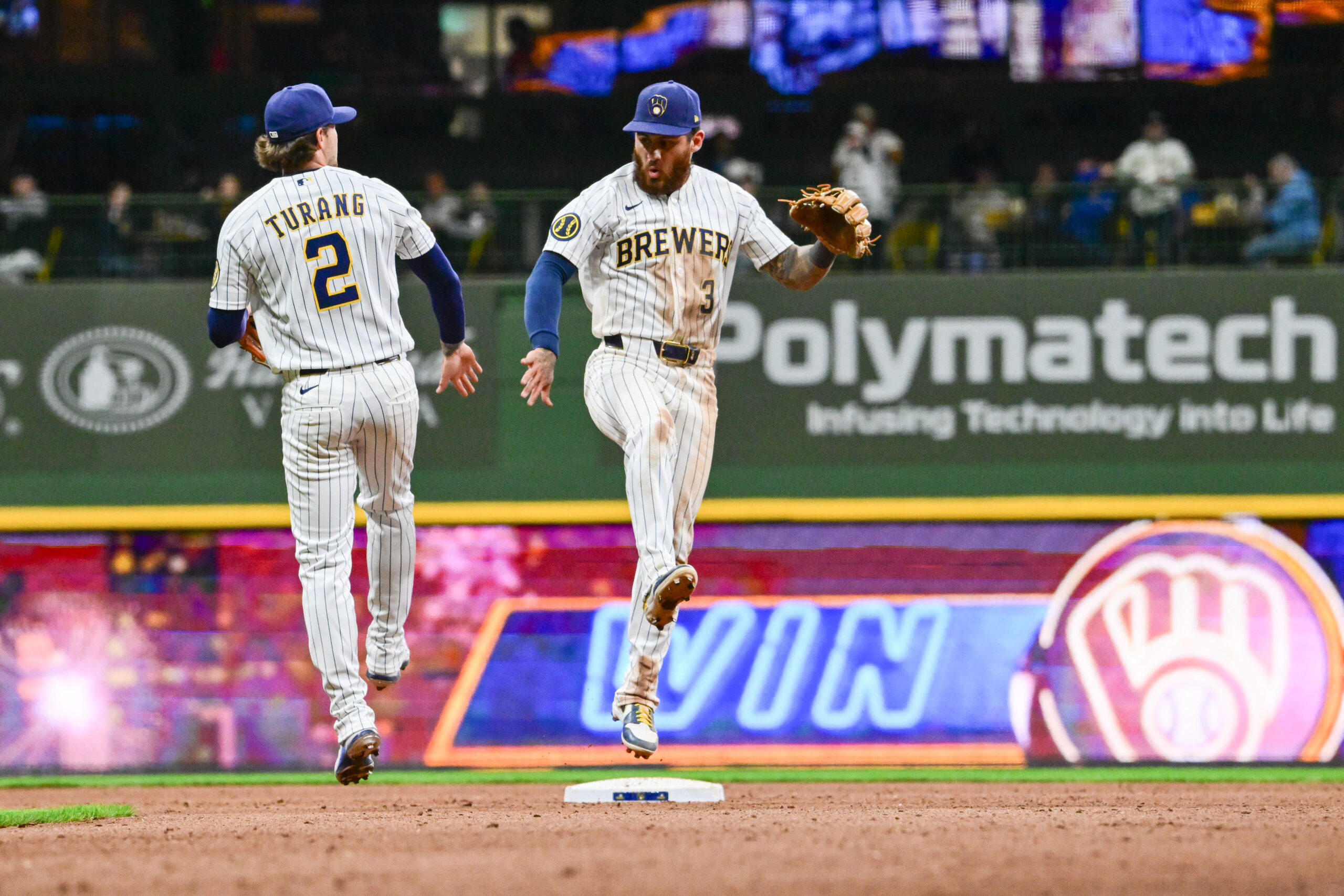 Mar 28, 2026; Milwaukee, Wisconsin, USA;  Milwaukee Brewers shortstop Joey Ortiz (3) and second baseman Brice Turang (2) celebrate after beating the Chicago White Sox at American Family Field. Mandatory Credit: Benny Sieu-Imagn Images