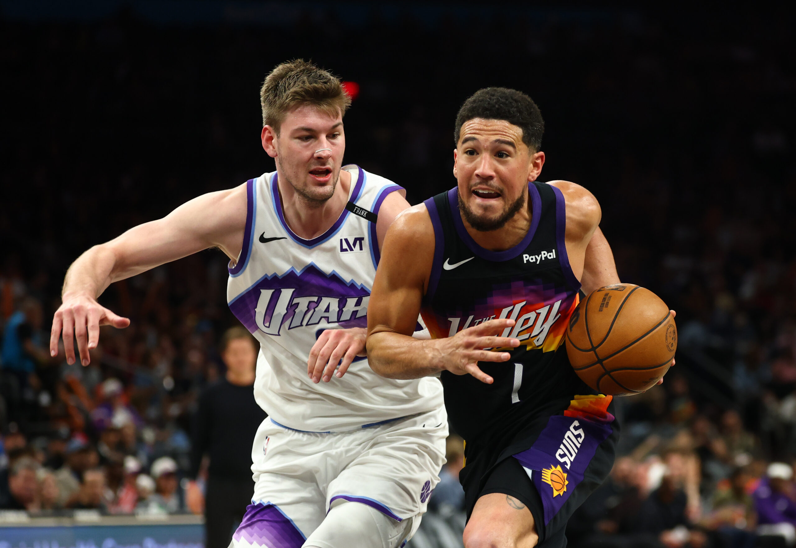 Mar 28, 2026; Phoenix, Arizona, USA; Phoenix Suns guard Devin Booker (1) moves the ball against Utah Jazz forward Kyle Filipowski (22) in the second half at Mortgage Matchup Center. Mandatory Credit: Mark J. Rebilas-Imagn Images