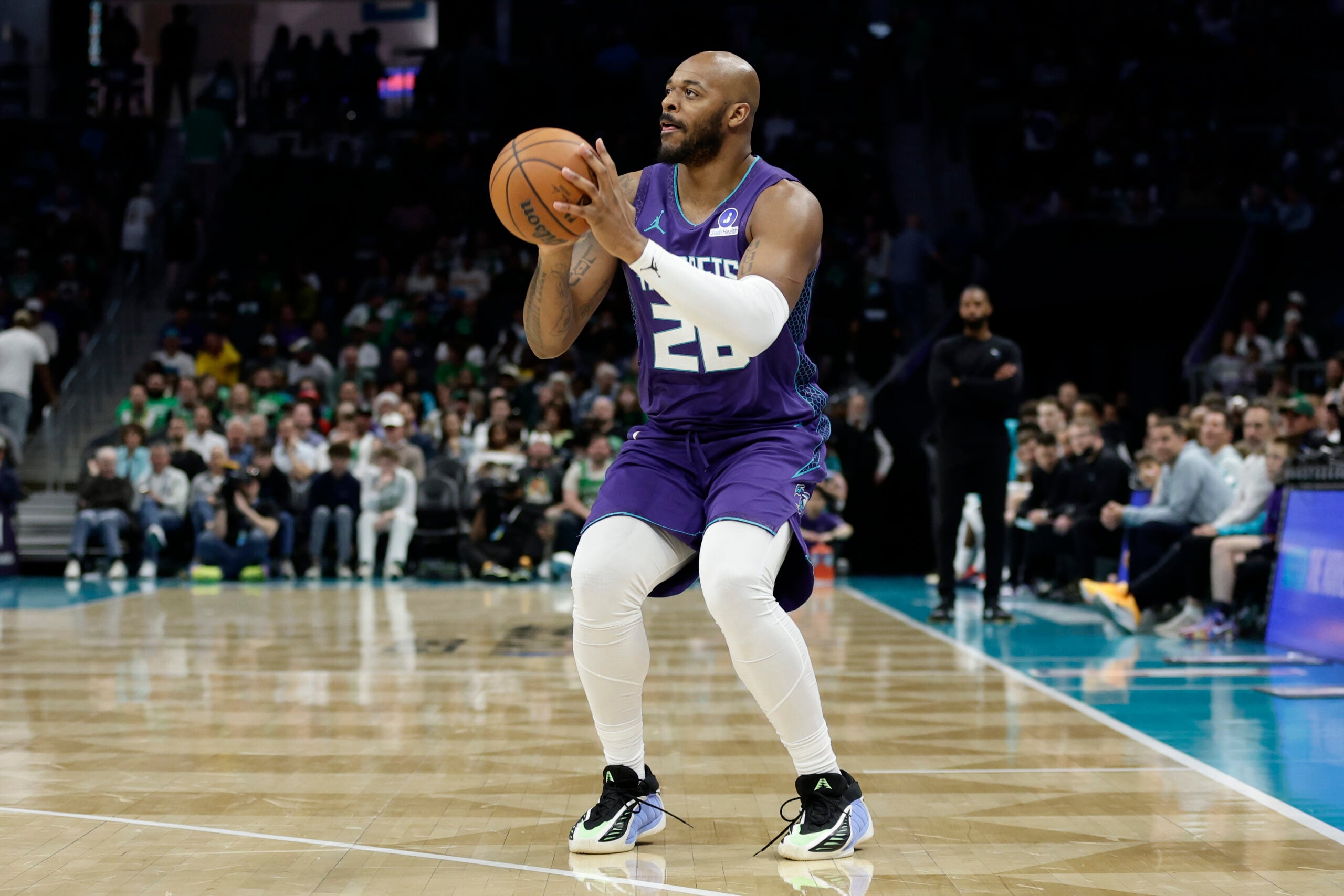Mar 29, 2026; Charlotte, North Carolina, USA; Charlotte Hornets forward Xavier Tillman (26) prepares to attempt a three-point shot during the second half against the Boston Celtics7 at Spectrum Center. Mandatory Credit: Brian Westerholt-Imagn Images