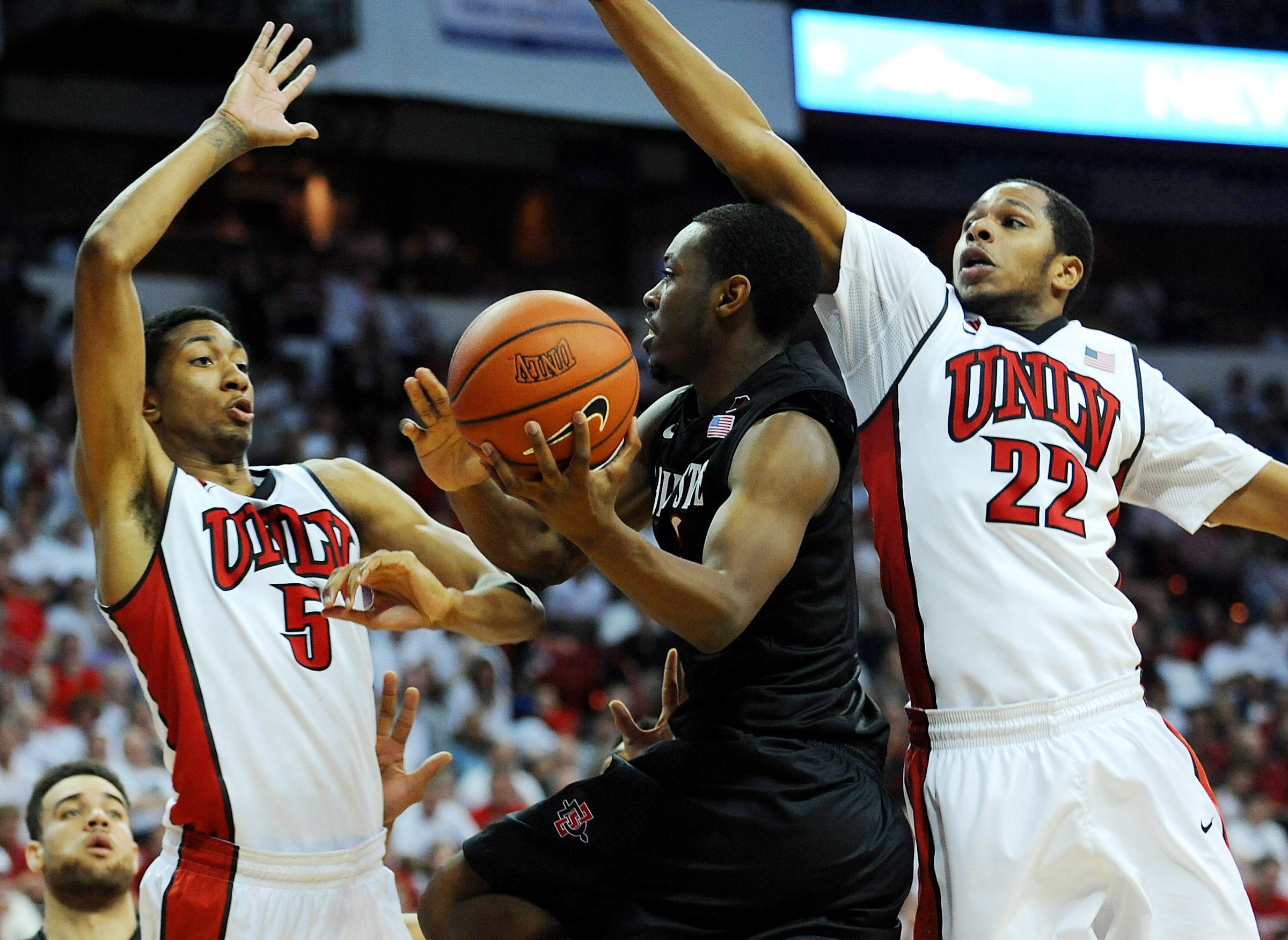 Mar 5, 2014; Las Vegas, NV, USA; San Diego State Aztecs guard Xavier Thames (2) attempts to shoot through the defense of UNLV Runnin' Rebels forward Christian Wood (5) and guard Jelan Kendrick (22) during an NCAA men's basketball game at Thomas and Mack Center. The Aztecs won the game 73-64. Mandatory Credit: Stephen R. Sylvanie-Imagn Images