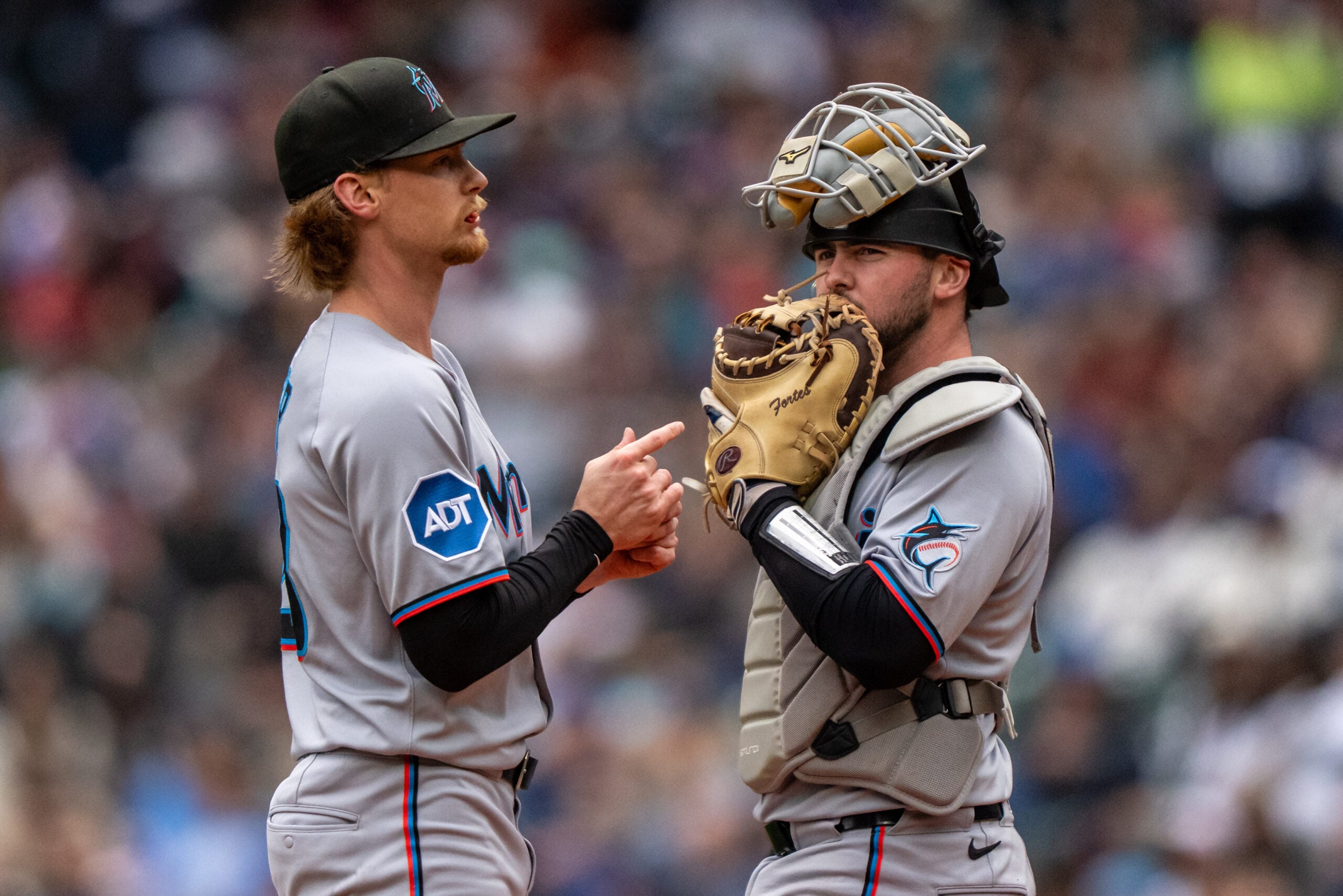 Apr 27, 2025; Seattle, Washington, USA;  Miami Marlins starting pitcher Max Meyer (23), left, and catcher Liam Hicks (34) meet at the mound during the second inning against the Seattle Mariners at Lumen Field. Mandatory Credit: Stephen Brashear-Imagn Images