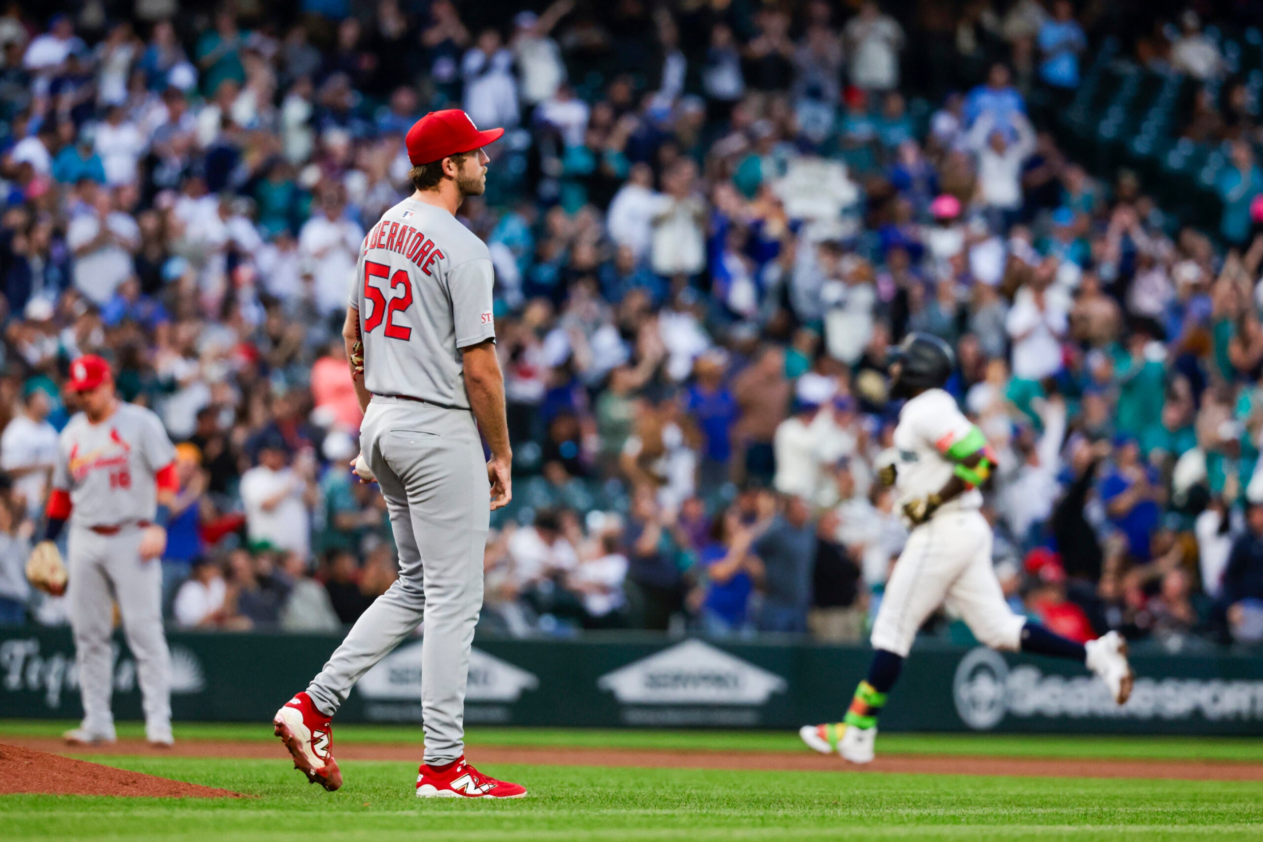Sep 9, 2025; Seattle, Washington, USA; St. Louis Cardinals starting pitcher Matthew Liberatore (52) walks around the mound after allowing a three-run home run to left fielder Randy Arozarena (56, background) during the third inning at T-Mobile Park. Mandatory Credit: Joe Nicholson-Imagn Images