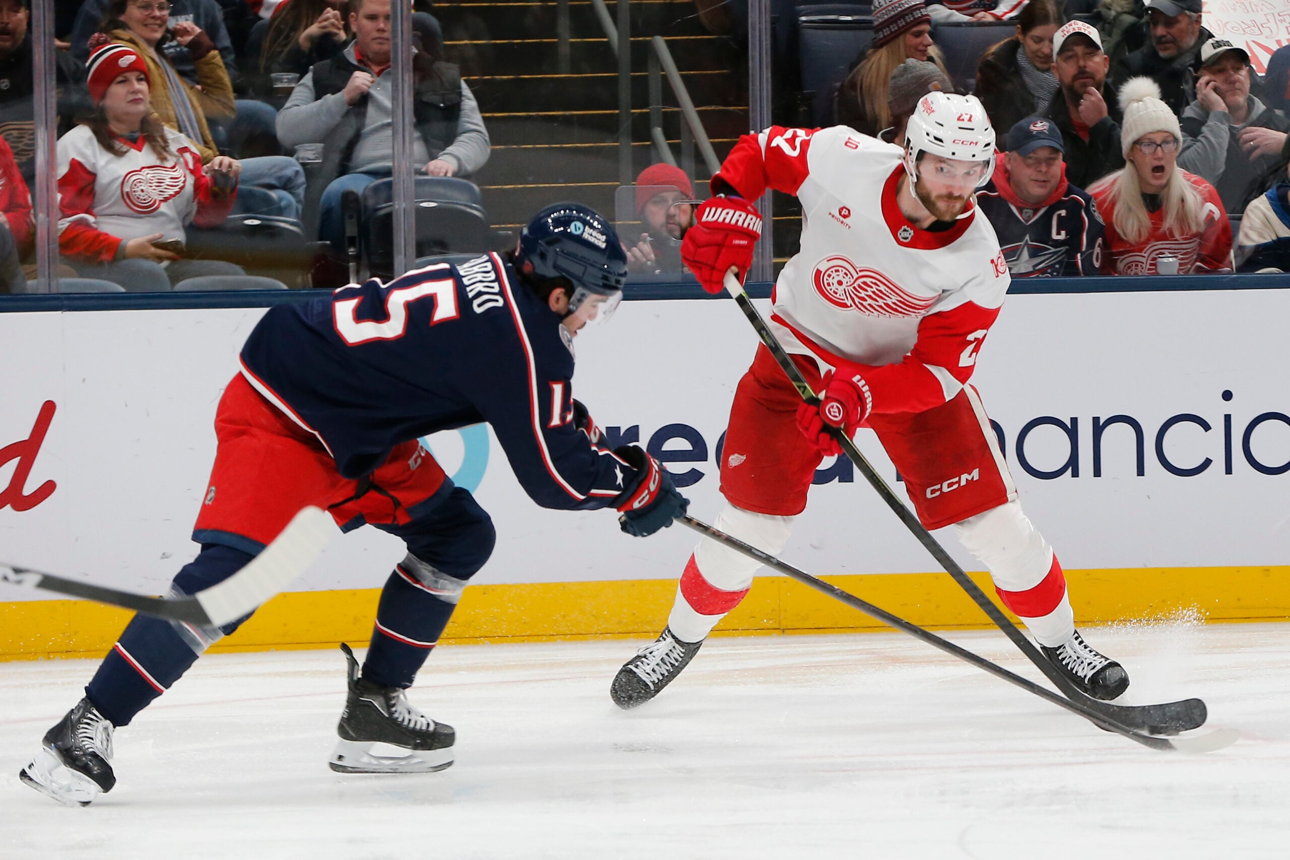 Dec 4, 2025; Columbus, Ohio, USA; Columbus Blue Jackets defenseman Dante Fabbro (15) blocks the attempt of Detroit Red Wings center Michael Rasmuss (27) during the third period at Nationwide Arena. Mandatory Credit: Russell LaBounty-Imagn Images