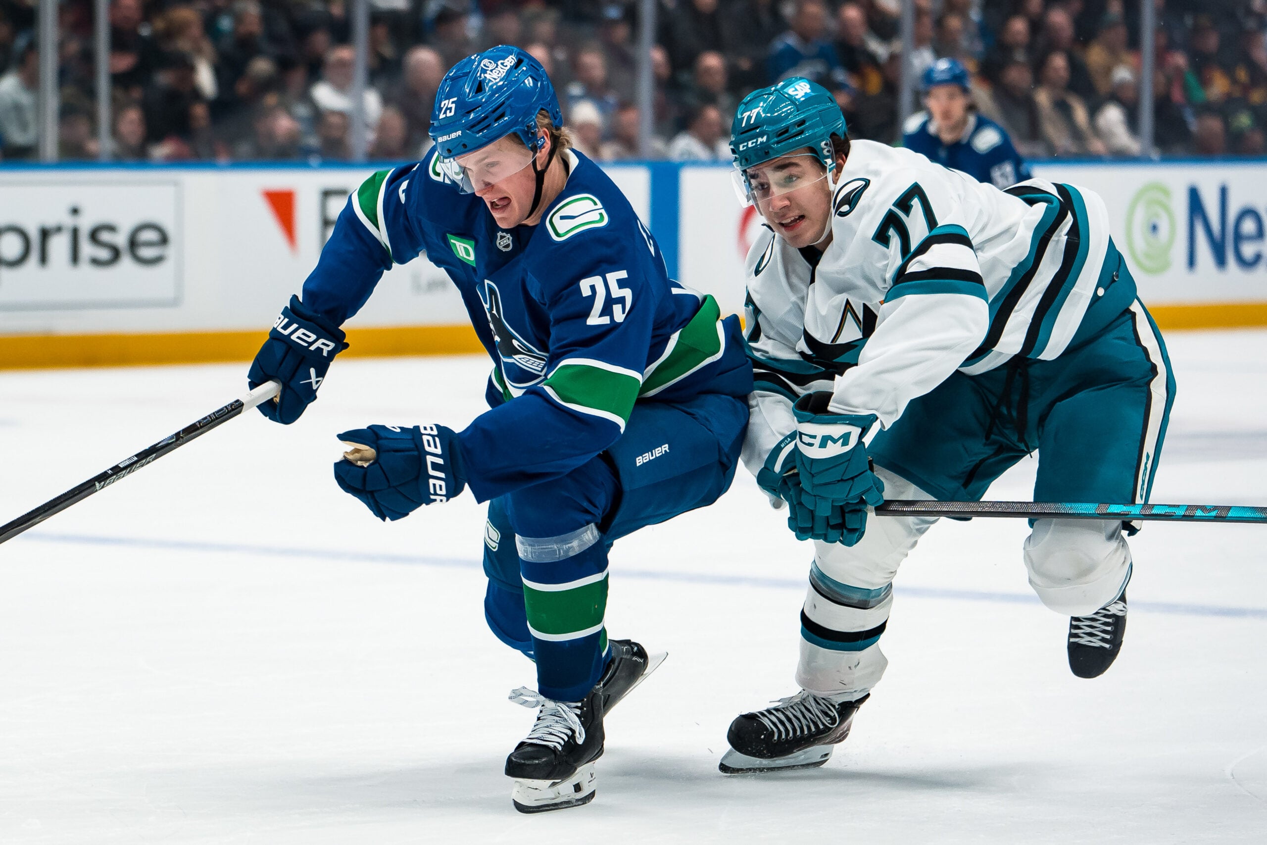 Jan 27, 2026; Vancouver, British Columbia, CAN; San Jose Sharks forward Michael Misa (77) battles with Vancouver Canucks defenseman Elias Pettersson (25) in the third period at Rogers Arena. Mandatory Credit: Bob Frid-Imagn Images