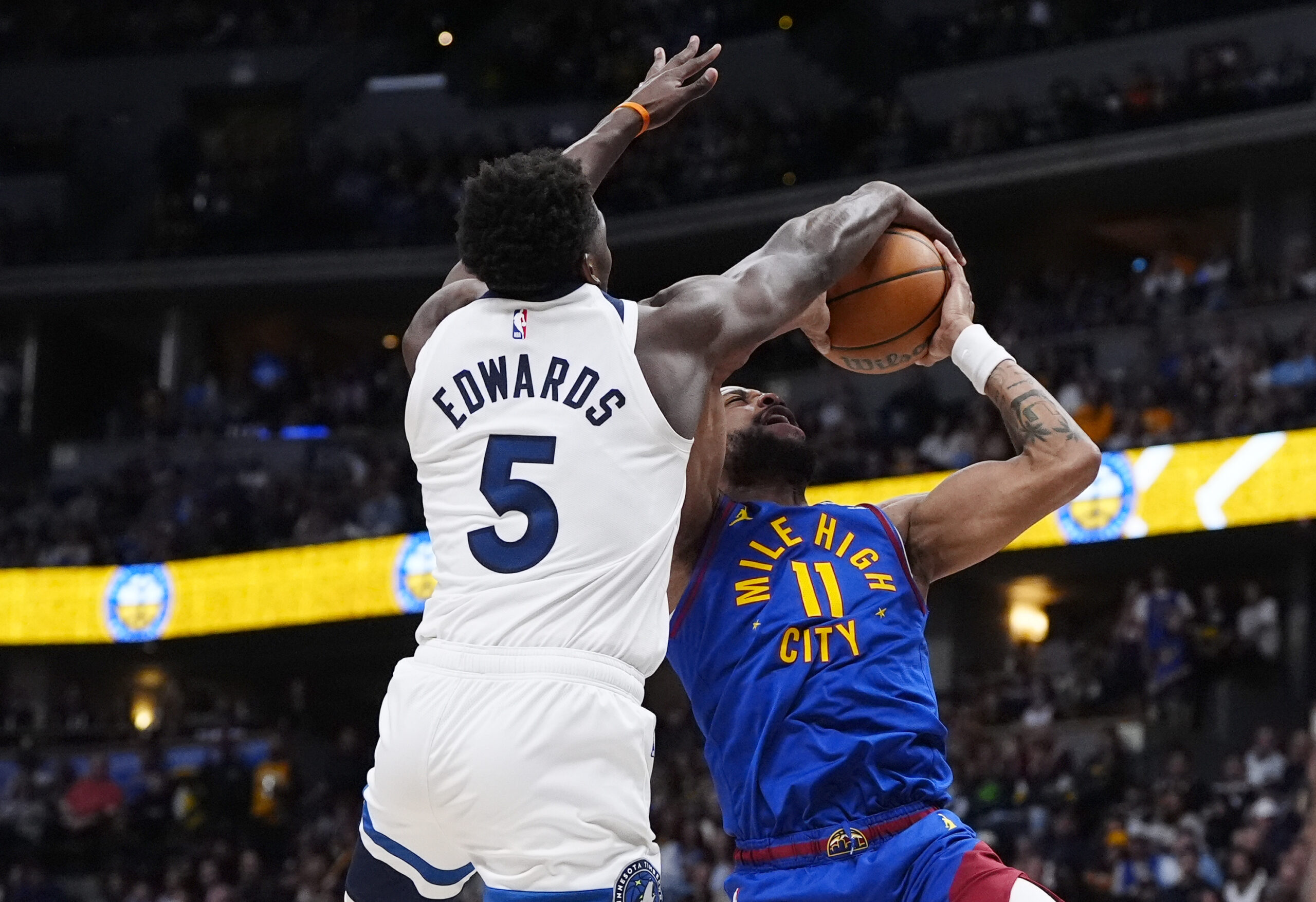 Mar 1, 2026; Denver, Colorado, USA; Minnesota Timberwolves guard Anthony Edwards (5) blocks the shot by Denver Nuggets guard Bruce Brown (11) in the second half at Ball Arena. Mandatory Credit: Ron Chenoy-Imagn Images