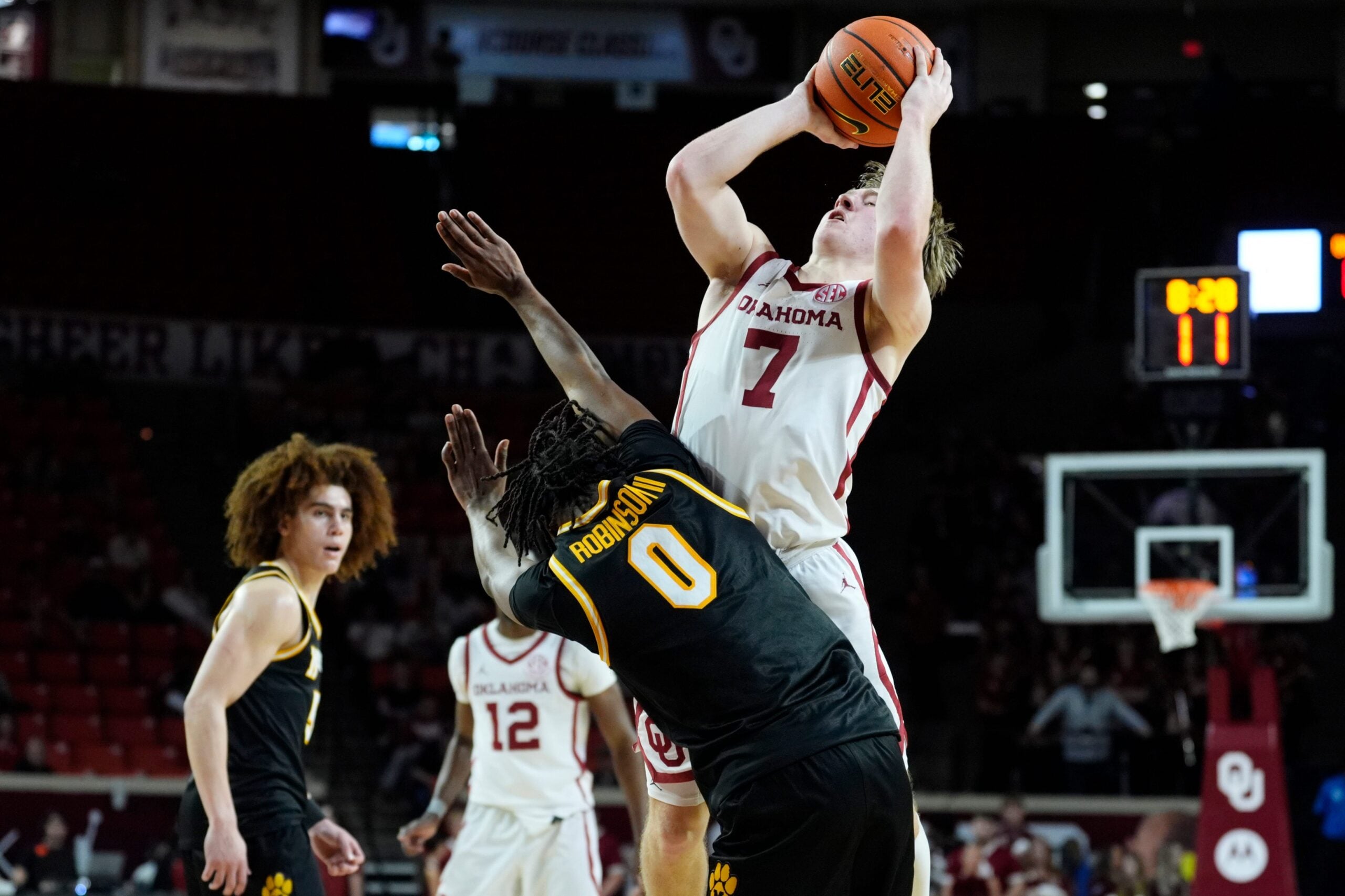 Oklahoma Sooners guard Dayton Forsythe (7) is fouled by Missouri Tigers guard Anthony Robinson II (0) as he shoots during an NCAA men's basketball game between the University of Oklahoma Sooners (OU) and the Missouri Tigers at Lloyd Noble Center in Norman, Okla., Tuesday, March 3, 2026. Oklahoma won 80-64.