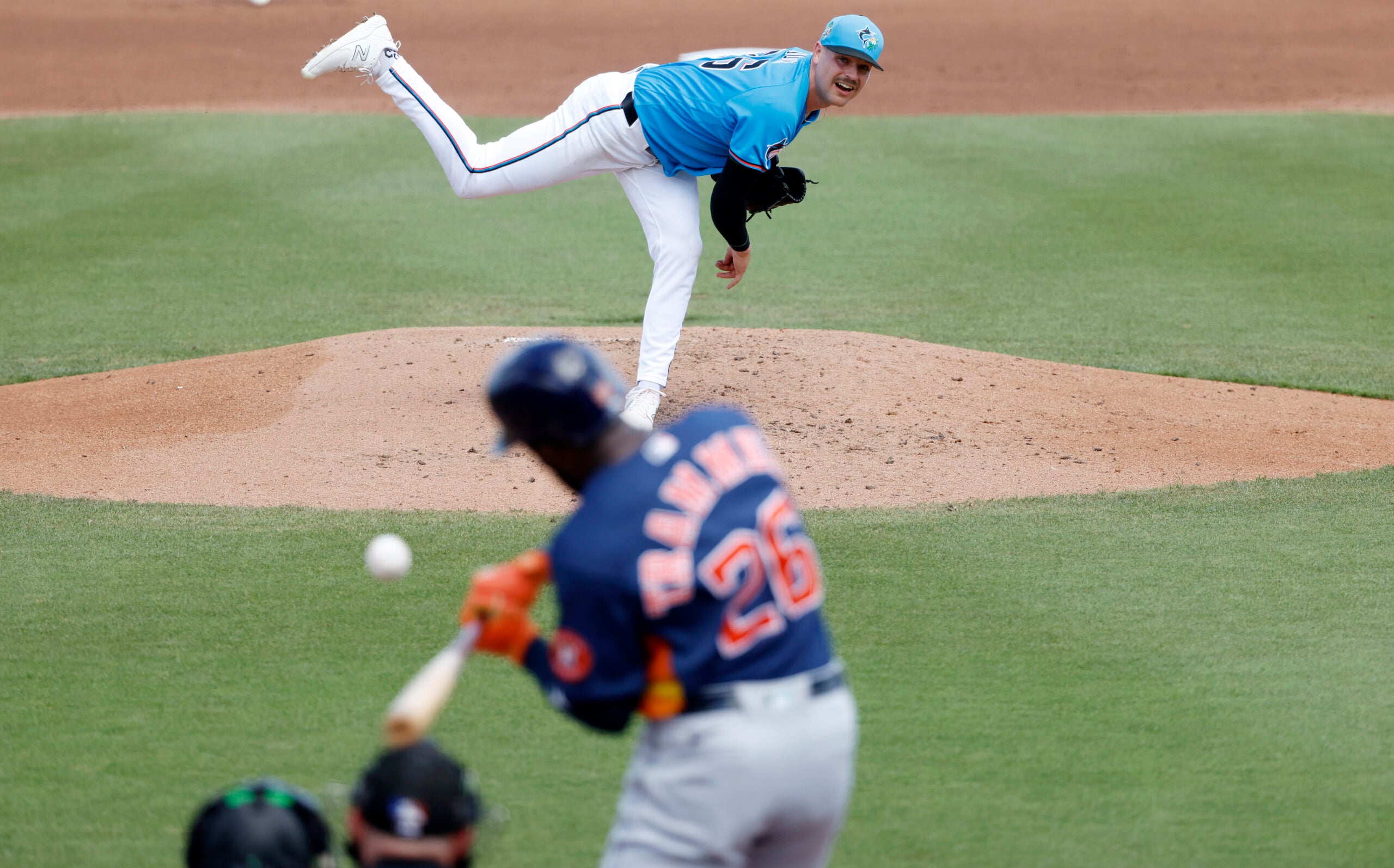 Mar 11, 2026; Jupiter, Florida, USA; Miami Marlins pitcher Janson Junk (26) pitches to by Houston Astros left fielder Taylor Trammell during the fourth inning at Roger Dean Chevrolet Stadium. Mandatory Credit: Rhona Wise-Imagn Images