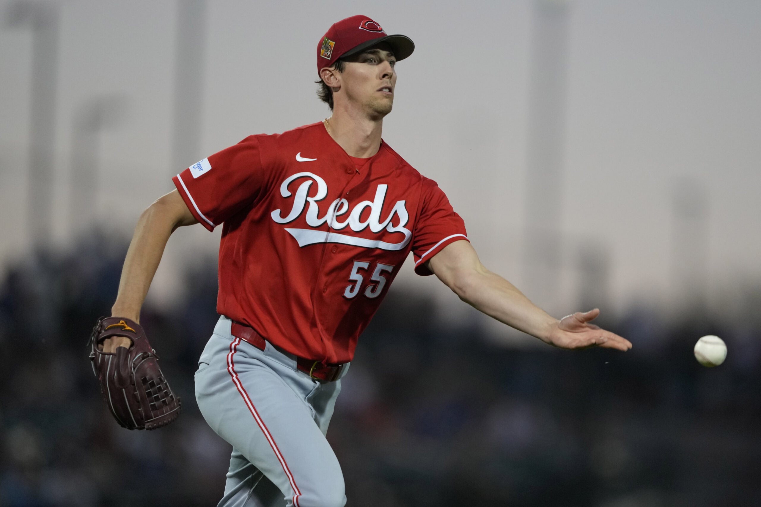 Mar 20, 2026; Mesa, Arizona, USA; Cincinnati Reds pitcher Brandon Williamson (55) flips the ball for an out against the Chicago Cubs in the third inning at Sloan Park. Mandatory Credit: Rick Scuteri-Imagn Images