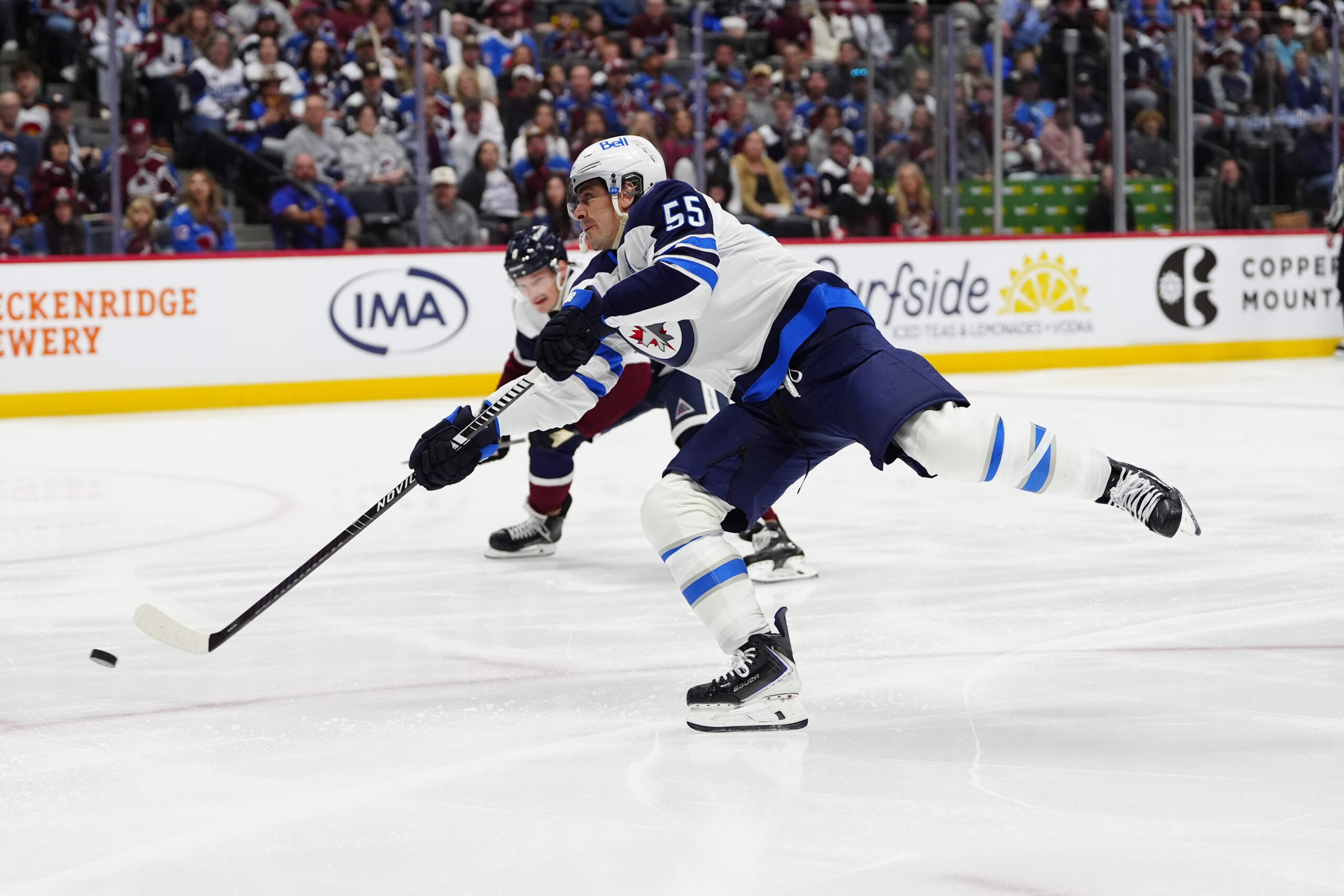 Mar 28, 2026; Denver, Colorado, USA; Winnipeg Jets center Mark Scheifele (55) shoots the puck in the first period against the Colorado Avalanche at Ball Arena. Mandatory Credit: Ron Chenoy-Imagn Images