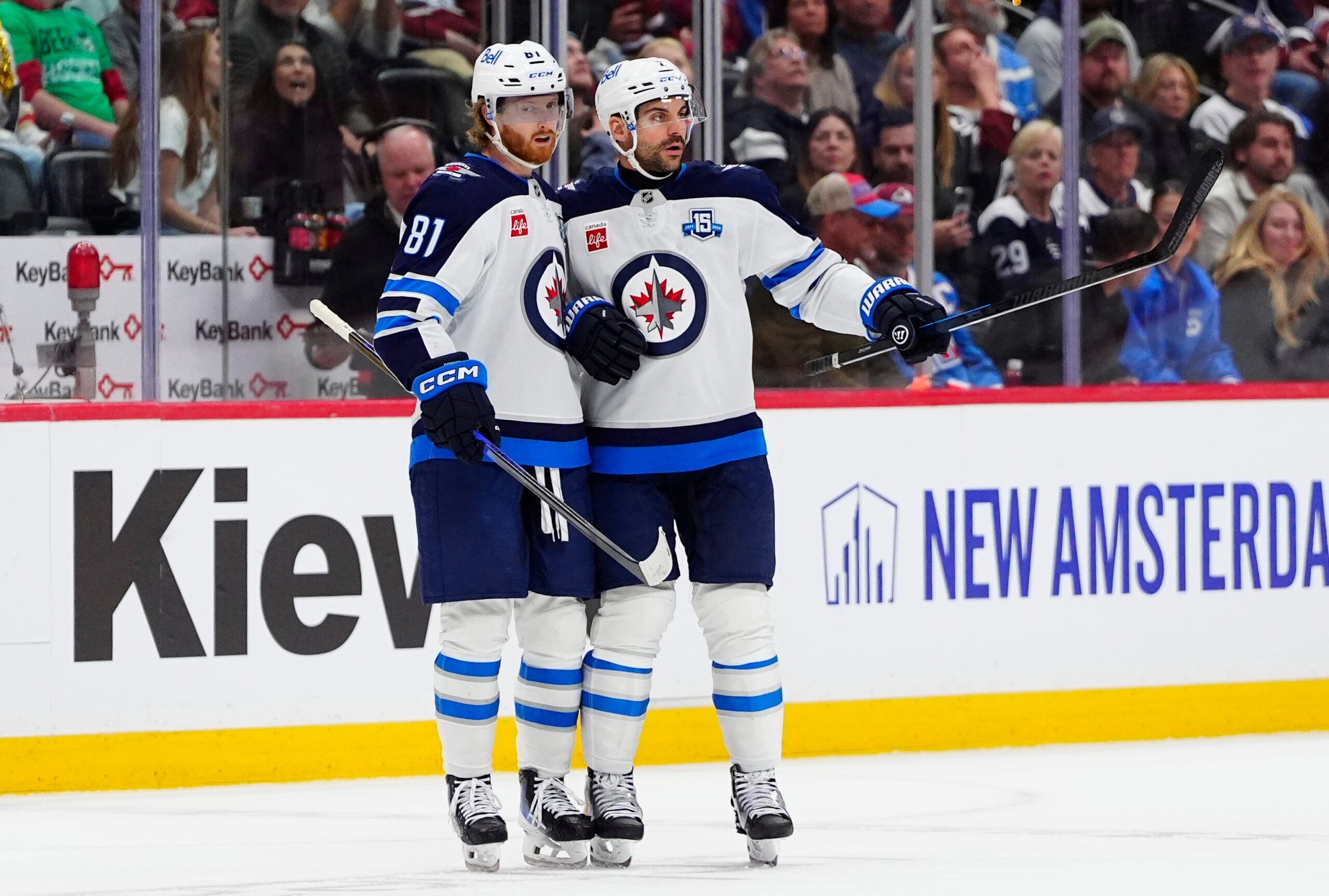 Mar 28, 2026; Denver, Colorado, USA; Winnipeg Jets left wing Kyle Connor (81) celebrates his empty net goal defenseman Dylan DeMelo (2) in the third period against the Colorado Avalanche at Ball Arena. Mandatory Credit: Ron Chenoy-Imagn Images