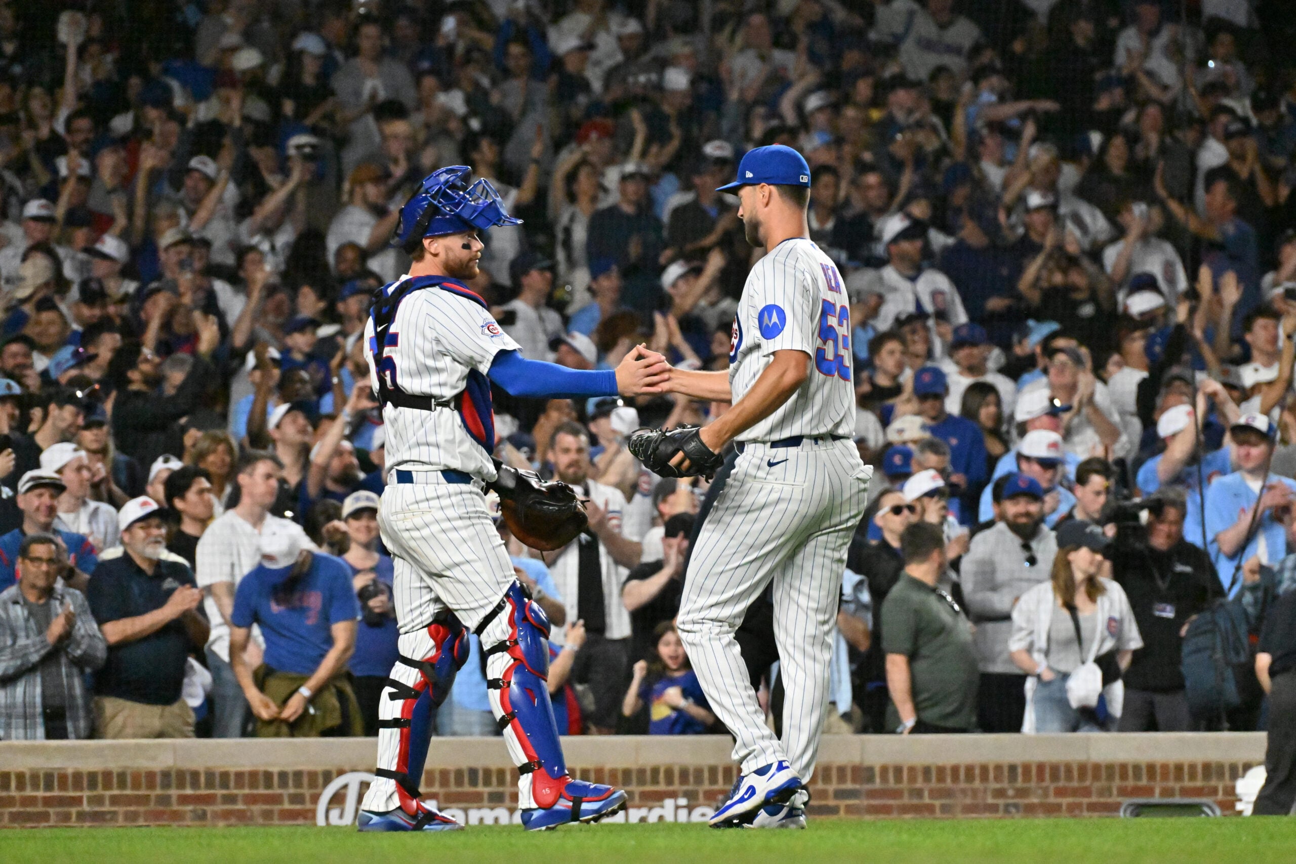 Mar 30, 2026; Chicago, Illinois, USA; Chicago Cubs catcher Carson Kelly (15) and pitcher Colin Rea (53) celebrate their victory over the Los Angeles Angels at Wrigley Field. Mandatory Credit: Patrick Gorski-Imagn Images