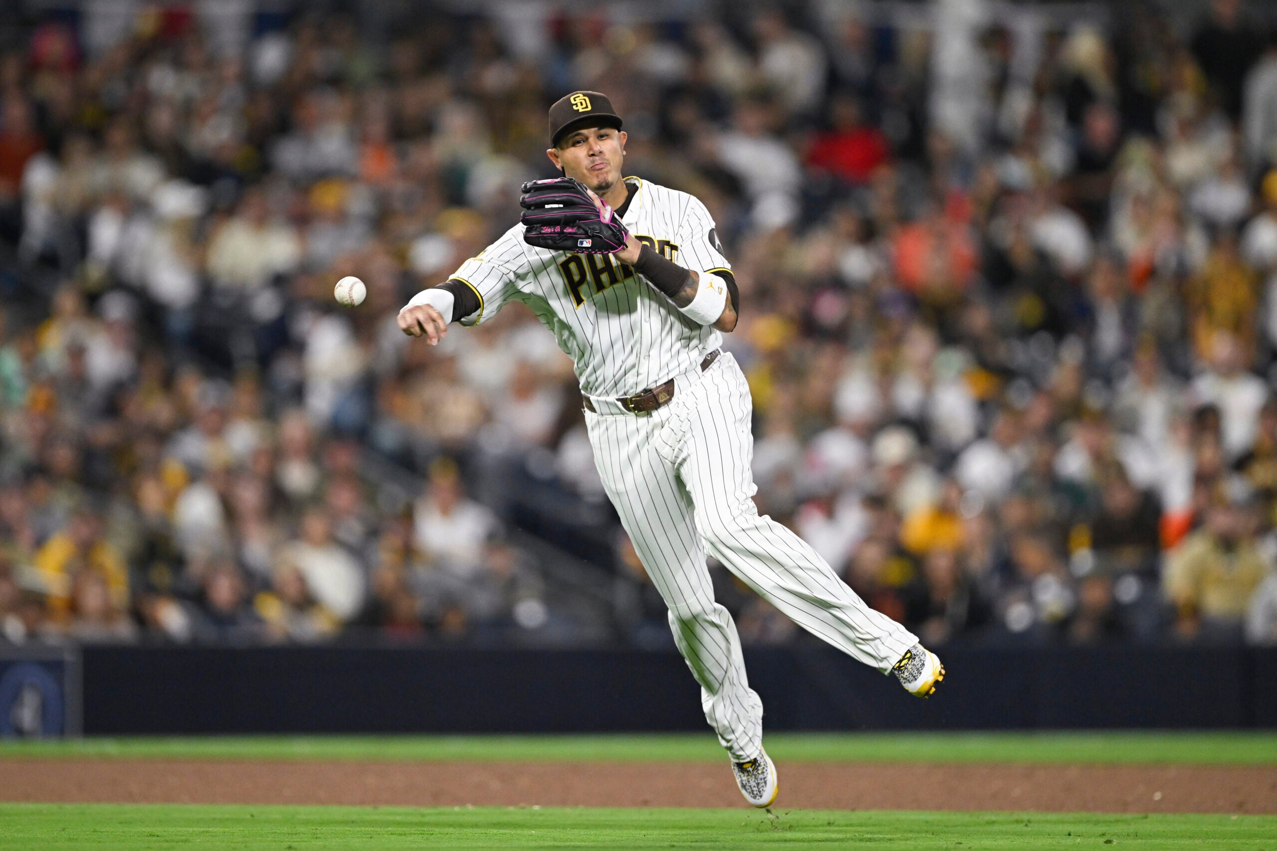 Mar 30, 2026; San Diego, California, USA; San Diego Padres third baseman Manny Machado (13) throws out San Francisco Giants third baseman Matt Chapman (26) during the sixth inning at Petco Park. Mandatory Credit: Denis Poroy-Imagn Images