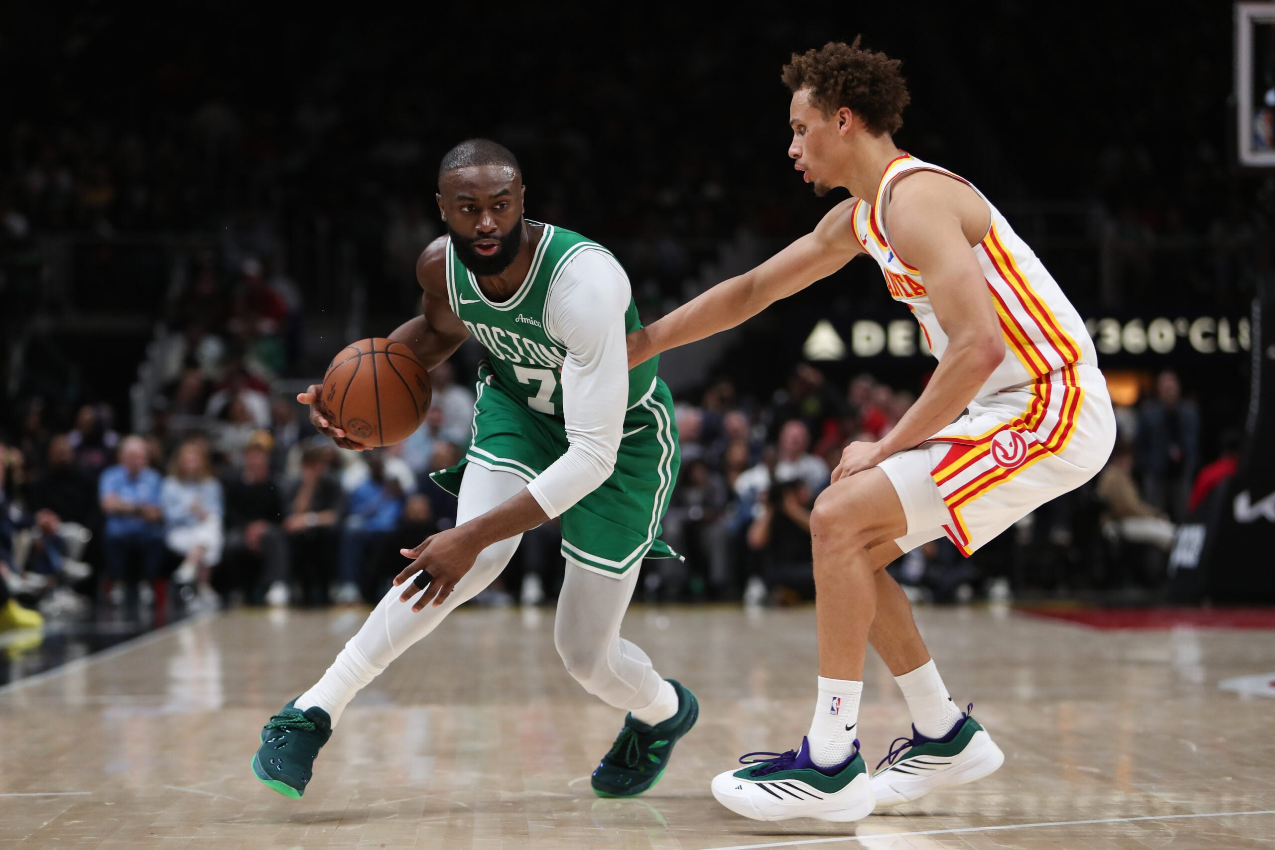 Mar 30, 2026; Atlanta, Georgia, USA; Boston Celtics guard Jaylen Brown (7) dribbles against Atlanta Hawks guard Dyson Daniels (5) in the first half at State Farm Arena. Mandatory Credit: Mady Mertens-Imagn Images