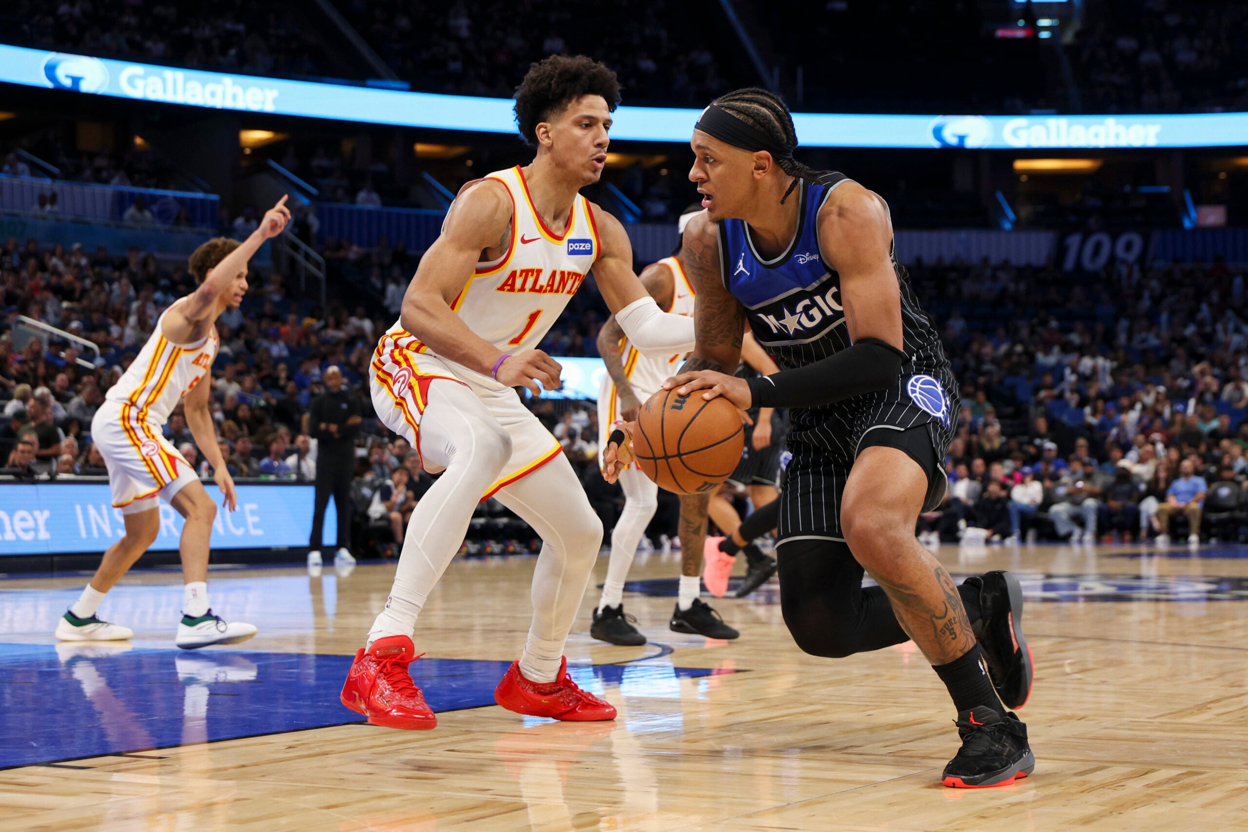 Apr 1, 2026; Orlando, Florida, USA; Orlando Magic forward Paolo Banchero (5) is guarded by Atlanta Hawks forward Jalen Johnson (1) in the third quarter at Kia Center. Mandatory Credit: Nathan Ray Seebeck-Imagn Images