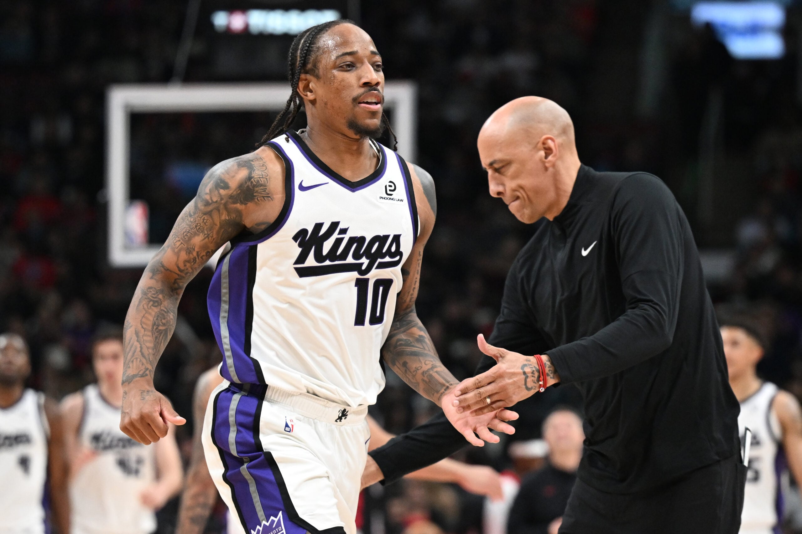 Apr 1, 2026; Toronto, Ontario, CAN;  Sacramento Kings forward DeMar DeRozan (10) slaps hands with head coach Doug Christie after making a three-point basket against the Toronto Raptors in the second half at Scotiabank Arena. Mandatory Credit: Dan Hamilton-Imagn Images