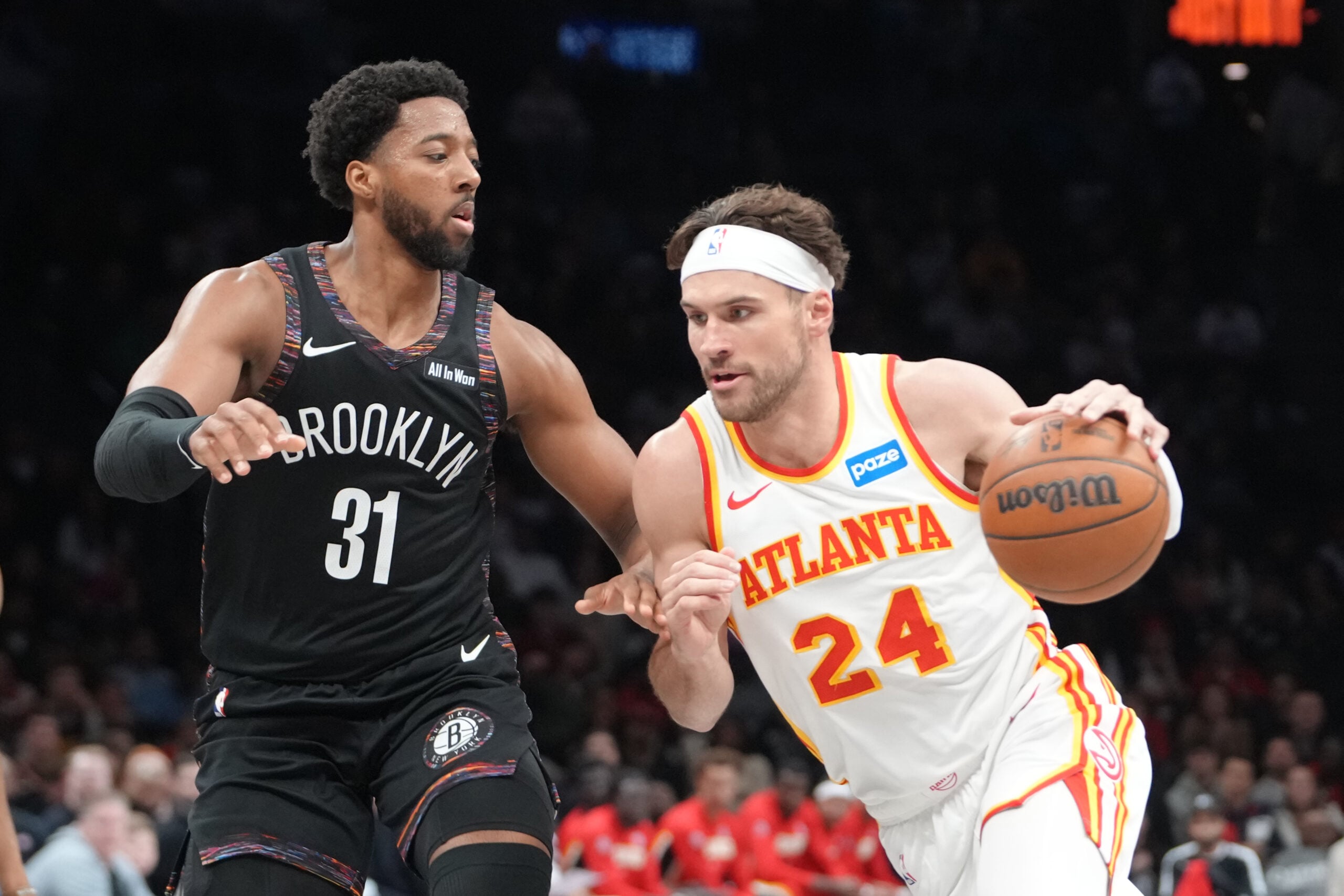 Apr 3, 2026; Brooklyn, New York, USA; Atlanta Hawks forward Corey Kispert (24) drives the ball against Brooklyn Nets forward Chaney Johnson (31) during the second half at Barclays Center. Mandatory Credit: Gregory Fisher-Imagn Images