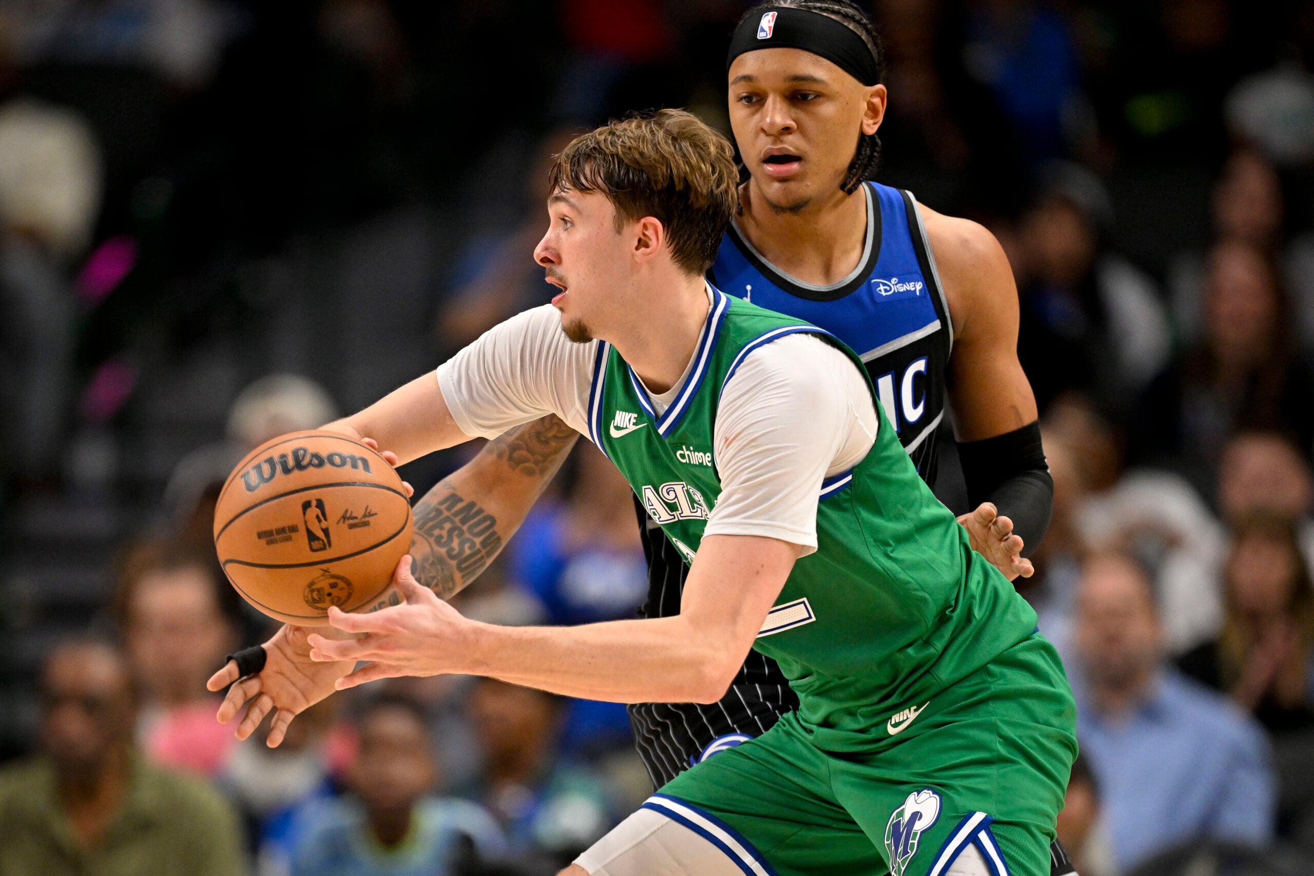 Apr 3, 2026; Dallas, Texas, USA; Dallas Mavericks forward Cooper Flagg (32) keeps the ball away from Orlando Magic forward Paolo Banchero (5) during the second half at the American Airlines Center. Mandatory Credit: Jerome Miron-Imagn Images