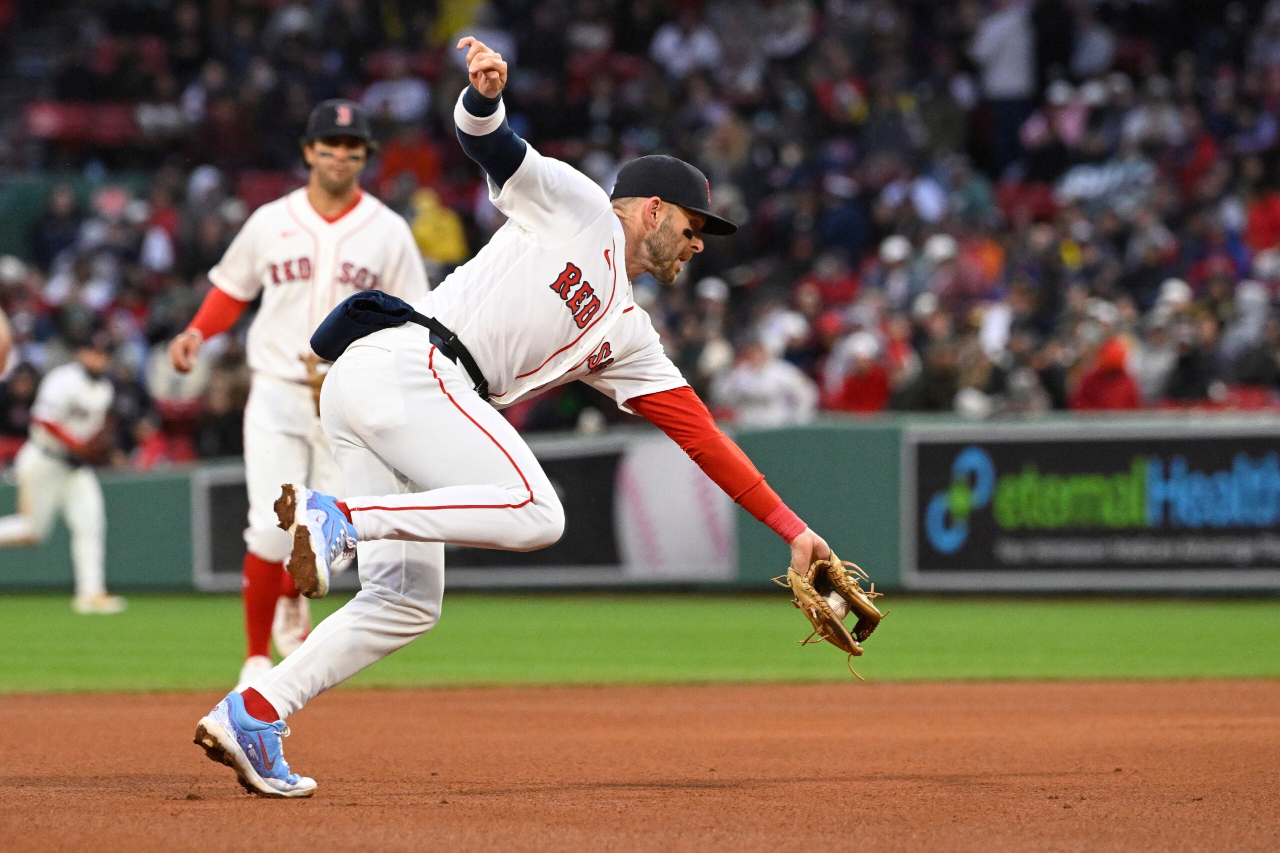 Apr 4, 2026; Foxborough, Massachusetts, USA; Boston Red Sox shortstop Trevor Story (10) makes a catch and throws the ball to first base for an out against the San Diego Padres during the eighth inning at Fenway Park. Mandatory Credit: Eric Canha-Imagn Images
