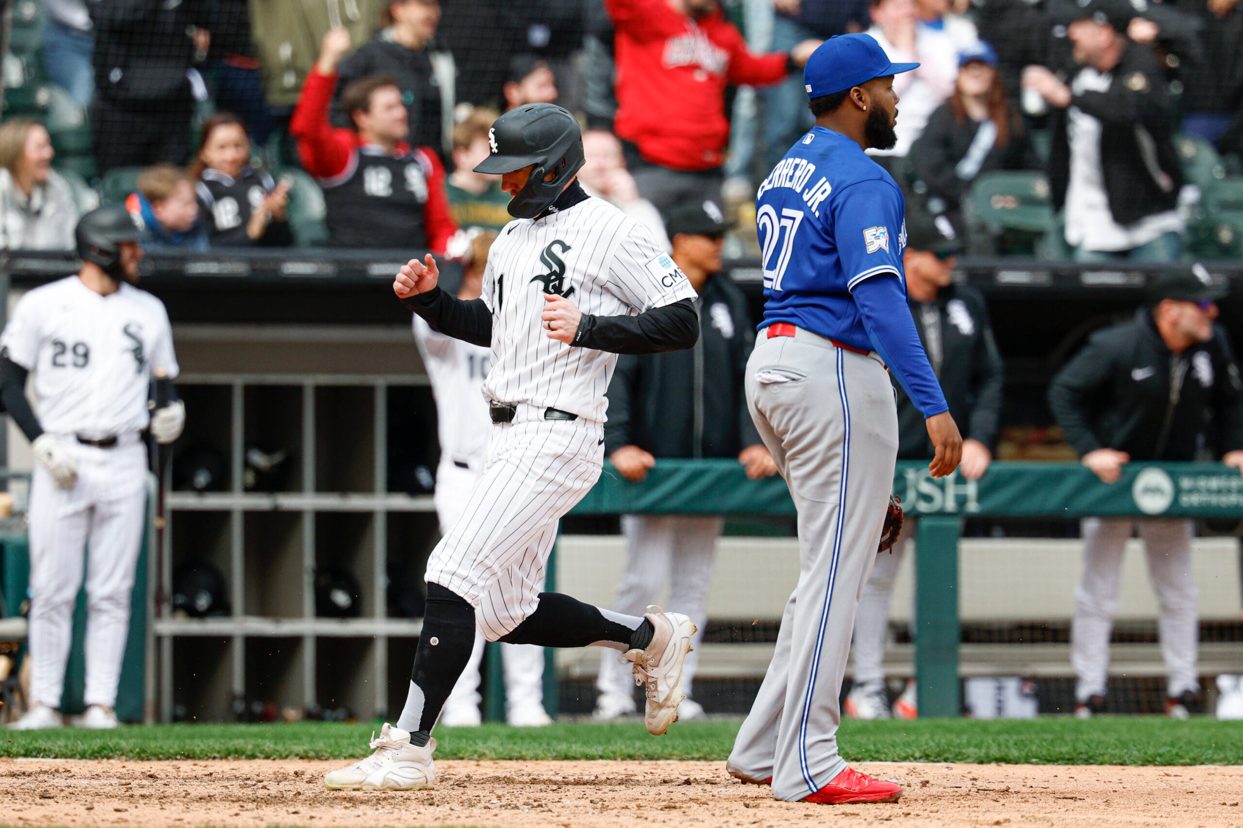 Apr 4, 2026; Chicago, Illinois, USA; Chicago White Sox left fielder Austin Hays (21) scores against the Toronto Blue Jays during the eight inning at Rate Field. Mandatory Credit: Kamil Krzaczynski-Imagn Images