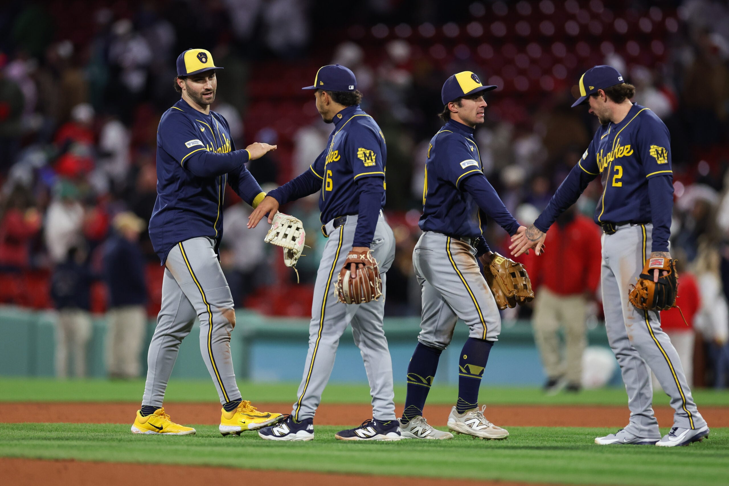 Apr 6, 2026; Boston, Massachusetts, USA; Milwaukee Brewers center fielder Garrett Mitchell (5) and Milwaukee Brewers right fielder Sal Frelick (10) celebrate after defeating the Boston Red Sox at Fenway Park. Mandatory Credit: Paul Rutherford-Imagn Images