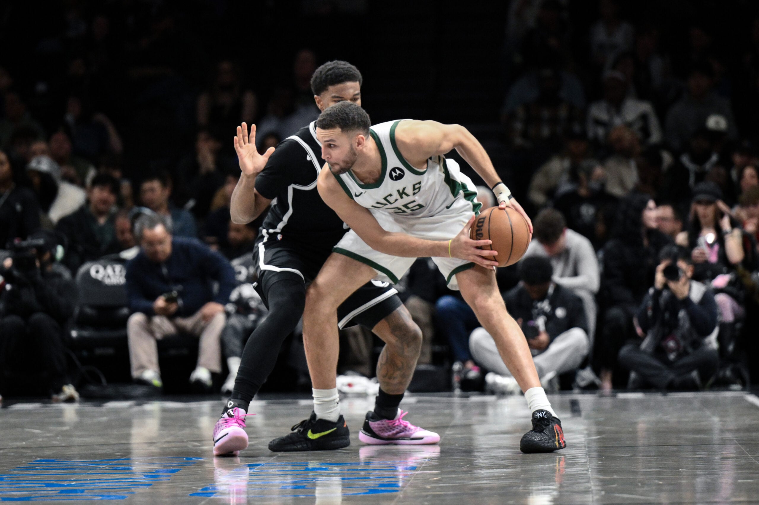 Apr 7, 2026; Brooklyn, New York, USA; Milwaukee Bucks forward Pete Nance (35) sets the play while defended by Brooklyn Nets forward E.J. Liddell (9) during the first half at Barclays Center. Mandatory Credit: John Jones-Imagn Images