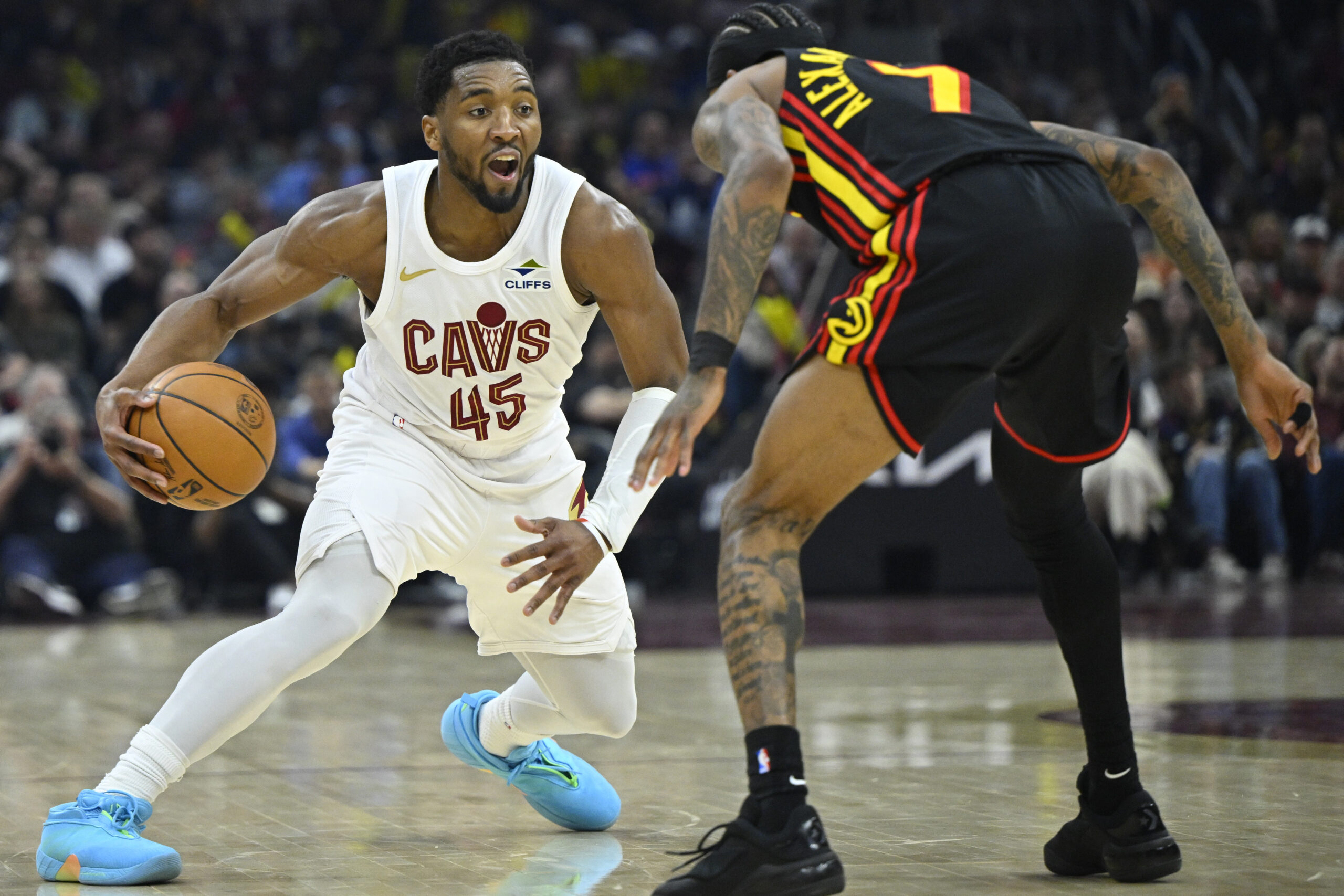 Apr 8, 2026; Cleveland, Ohio, USA; Cleveland Cavaliers guard Donovan Mitchell (45) dribbles defended by Atlanta Hawks guard Nickeil Alexander-Walker (7) in the third quarter at Rocket Arena. Mandatory Credit: David Richard-Imagn Images