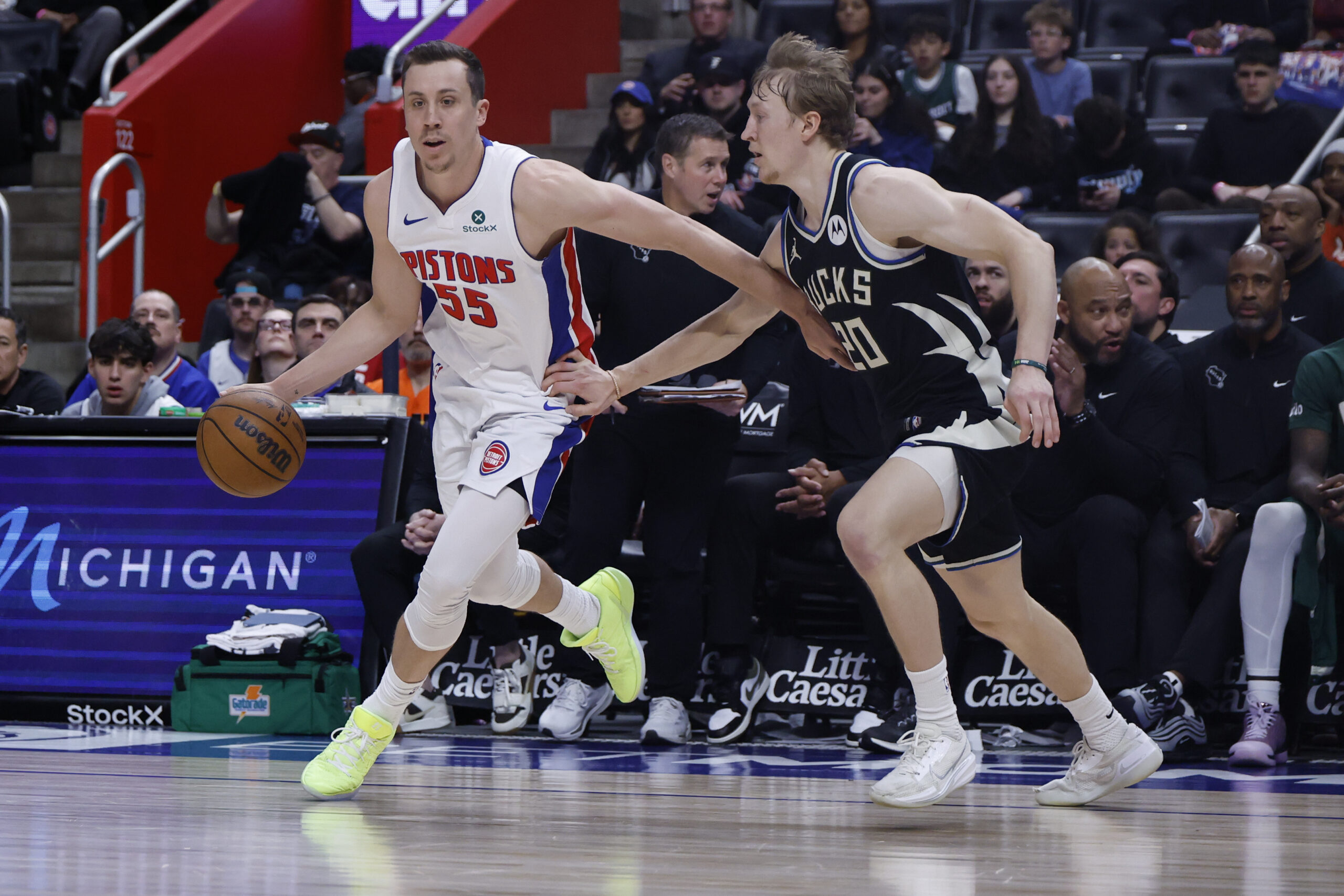 Apr 08, 2026; Detroit, Michigan, USA; Detroit Pistons forward Duncan Robinson (55) dribbles defended by Milwaukee Bucks guard AJ Green (20) in the second half at Little Caesars Arena. Mandatory Credit: Rick Osentoski-Imagn Images