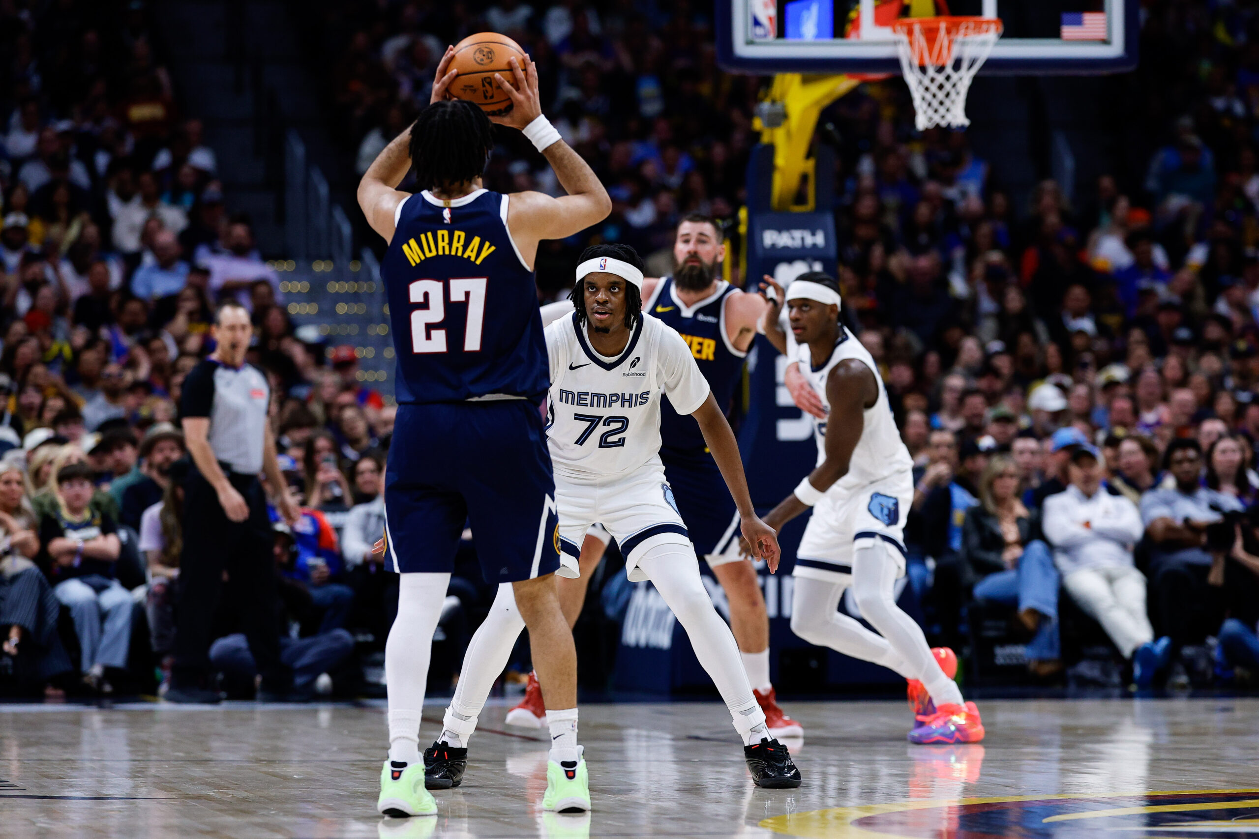 Apr 8, 2026; Denver, Colorado, USA; Denver Nuggets guard Jamal Murray (27) controls the ball against Memphis Grizzlies guard Adama Bal (72) as center Jonas Valanciunas (17) and forward Taylor Hendricks (22) battle for position in the fourth quarter at Ball Arena. Mandatory Credit: Isaiah J. Downing-Imagn Images