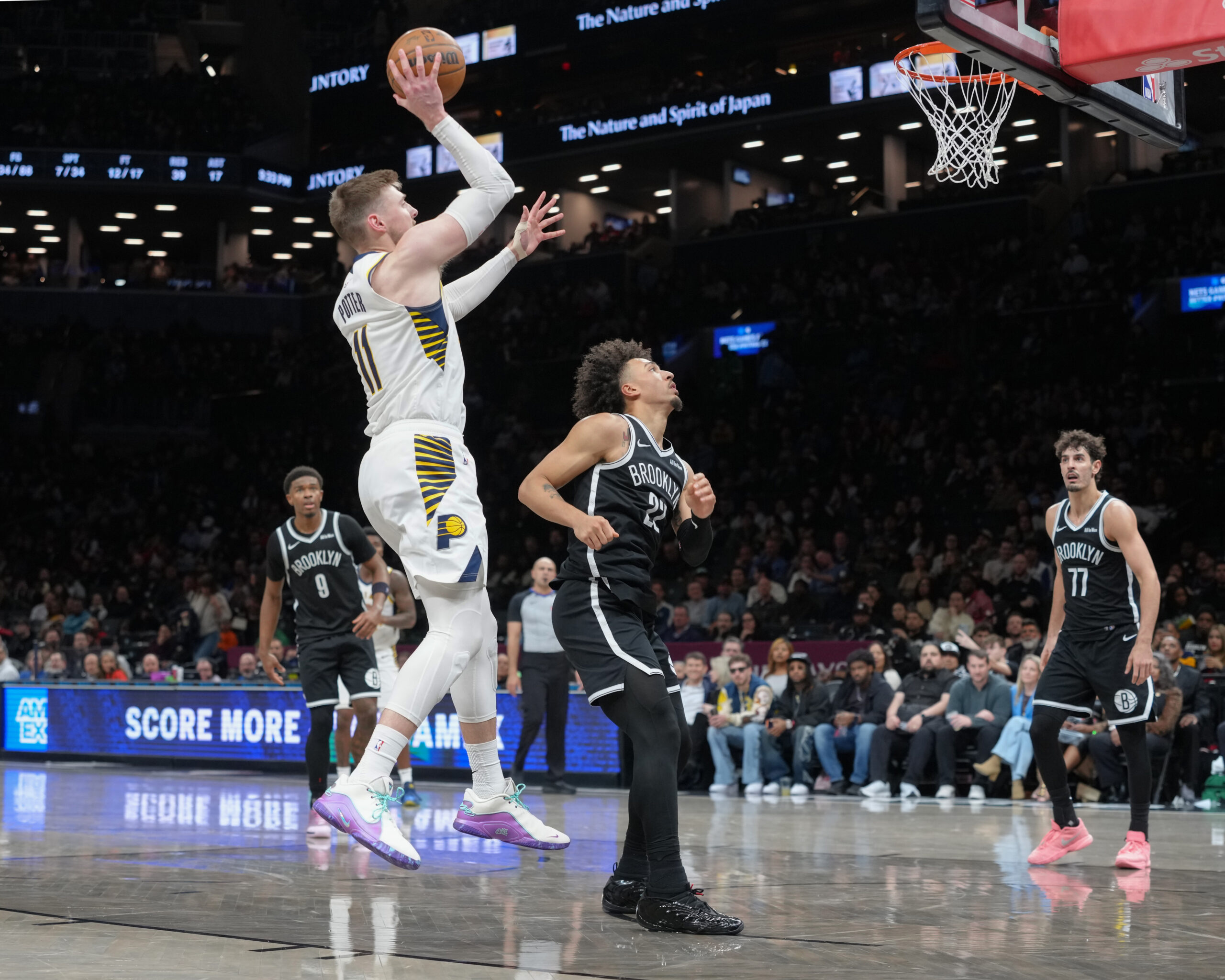 Apr 9, 2026; Brooklyn, New York, USA; Indiana Pacers center Micah Potter (11) shoots the ball against Brooklyn Nets forward Jalen Wilson (22) during the second half at Barclays Center. Mandatory Credit: Gregory Fisher-Imagn Images