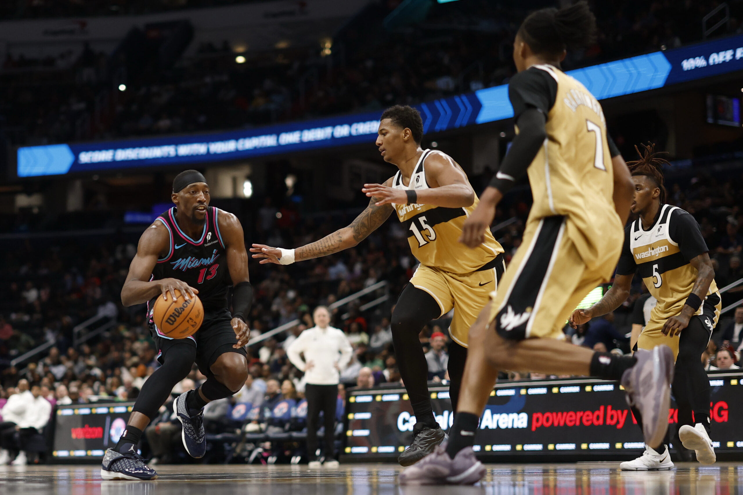 Apr 10, 2026; Washington, District of Columbia, USA; Miami Heat center Bam Adebayo (13) drives to the basket as Washington Wizards forward Julian Reese (15) defends in the first half at Capital One Arena. Mandatory Credit: Geoff Burke-Imagn Images