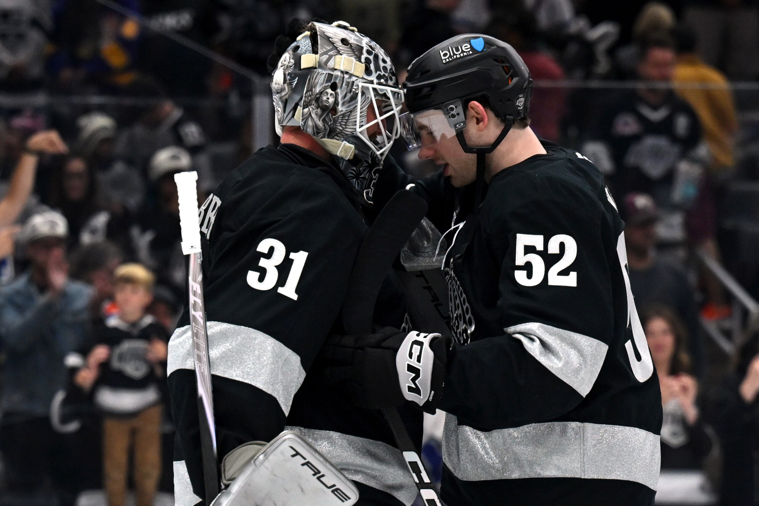 Apr 11, 2026; Los Angeles, California, USA; Los Angeles Kings goaltender Anton Forsberg (31) and Los Angeles Kings right wing Taylor Ward (52) celebrate after the win against the Edmonton Oilers at Crypto.com Arena. Mandatory Credit: Griffin Hooper-Imagn Images